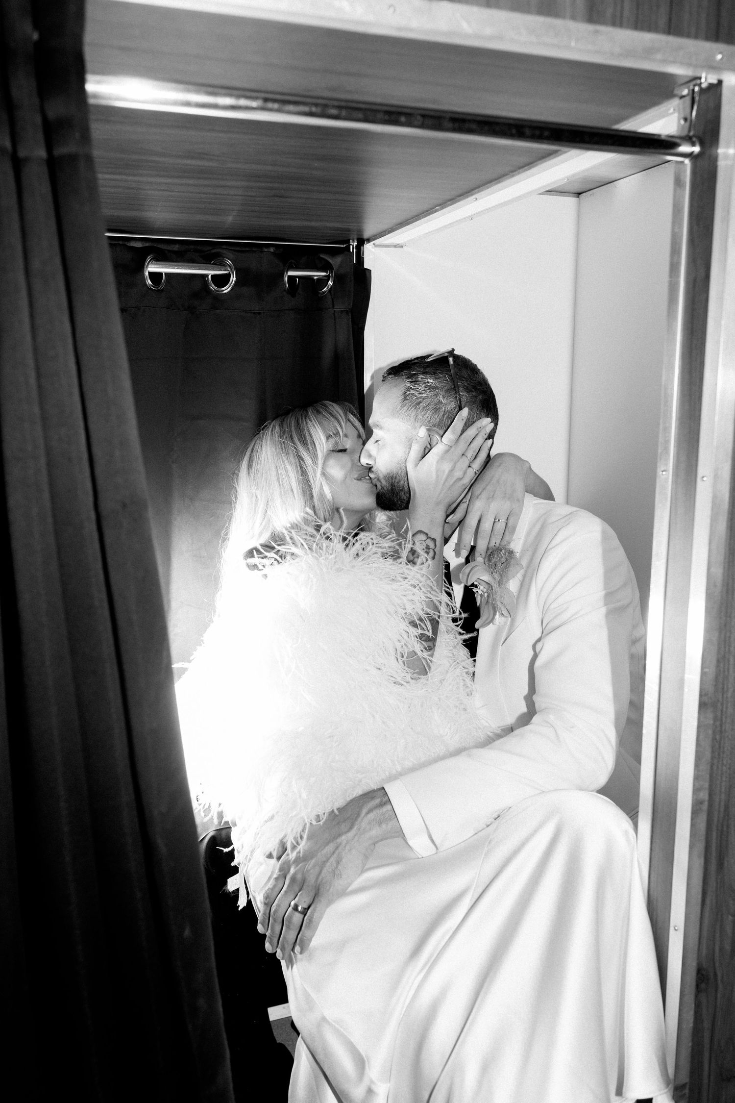 Black and white intimate portraits of couple sharing romantic moments in private.