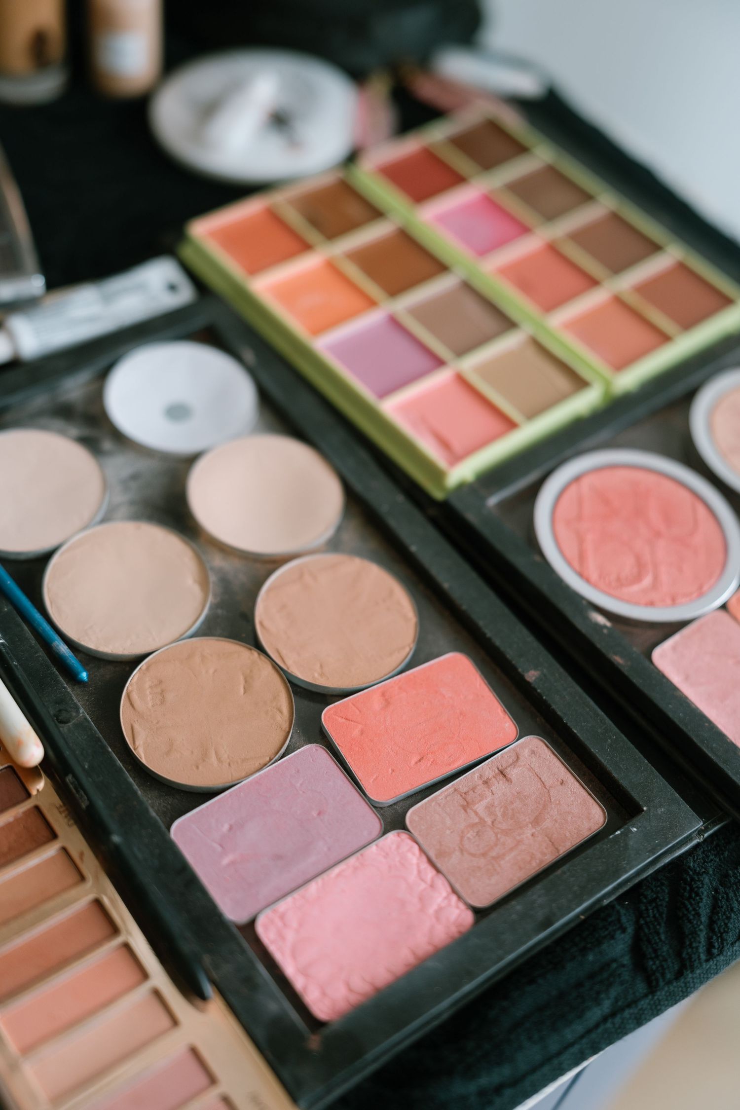 Close-up of makeup palette with pink and peach blush and bronzer shades.