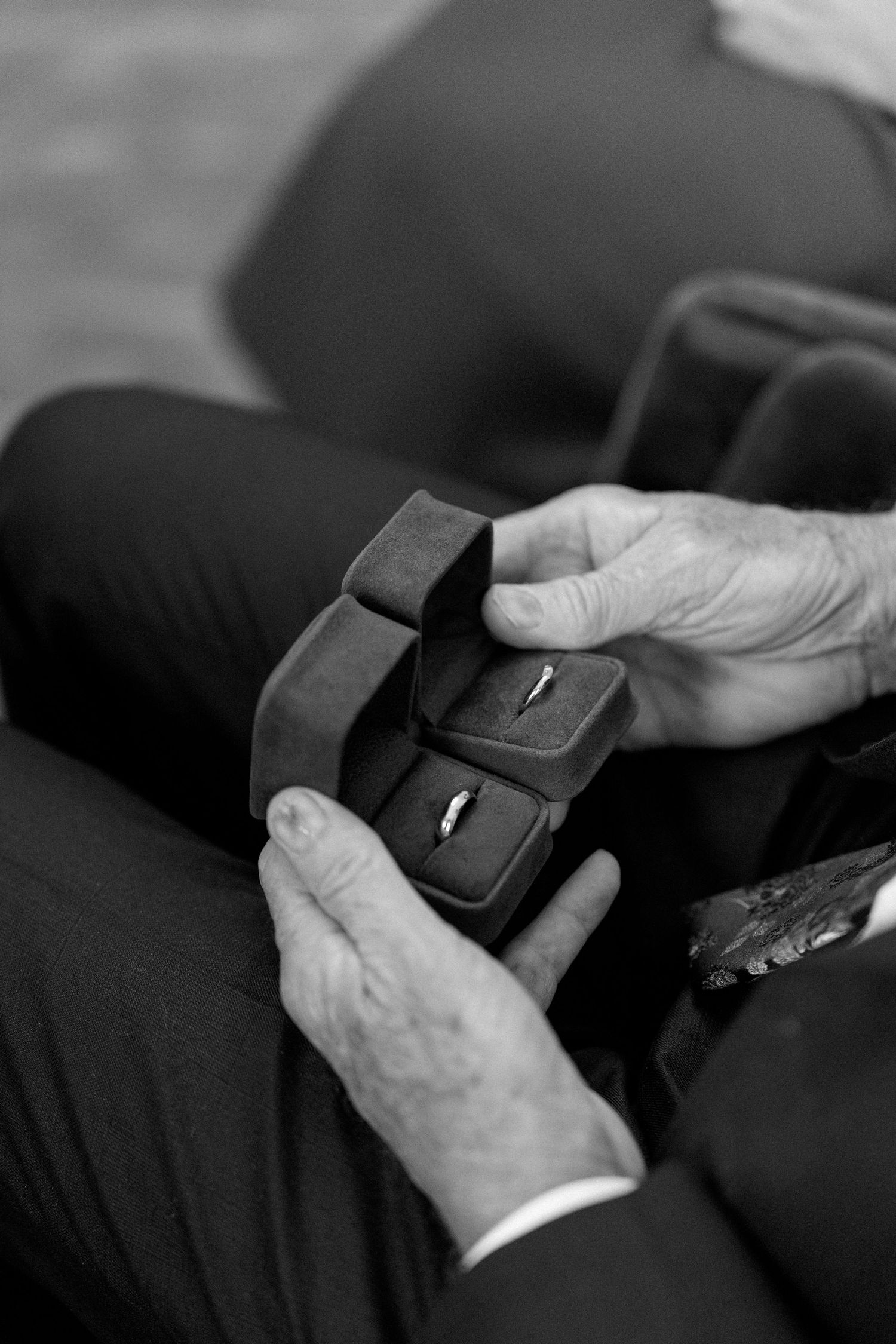Close-up of hands holding a ring box during wedding ceremony.