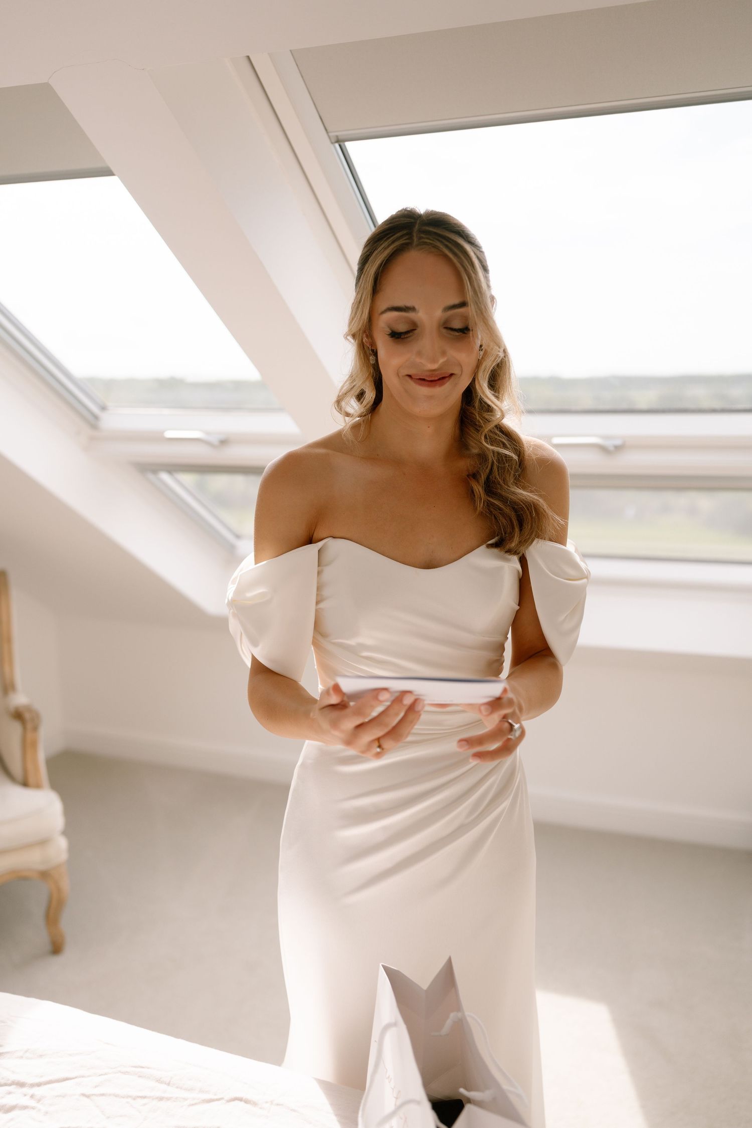 Wedding dress preparation sequence in bright white attic space.