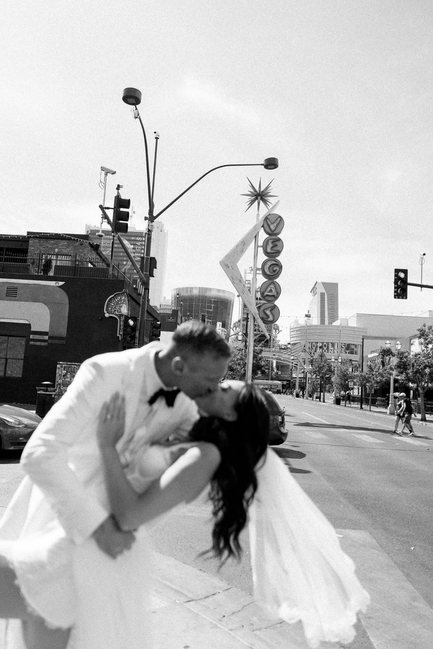 Black and white sequence of a dramatic dance dip on an urban street.