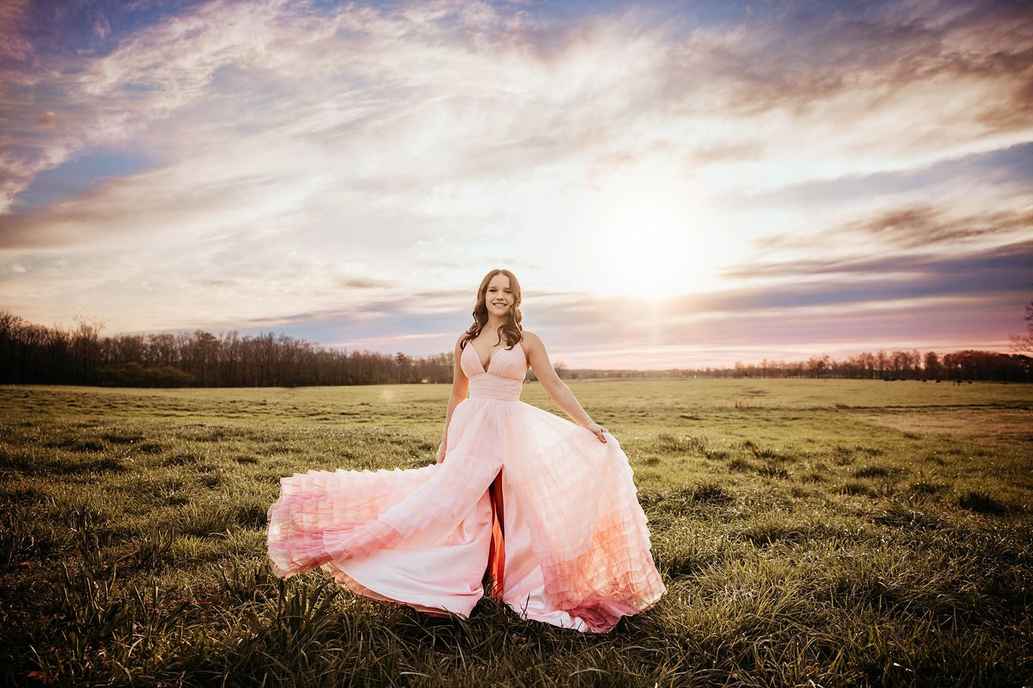 Ethereal sunset photo of a flowing pink dress in an open field.