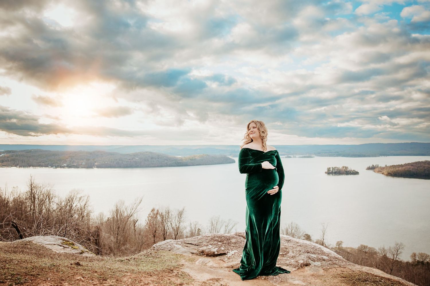 A stunning winter photoshoot along a snowy coastline at sunset with dramatic clouds.