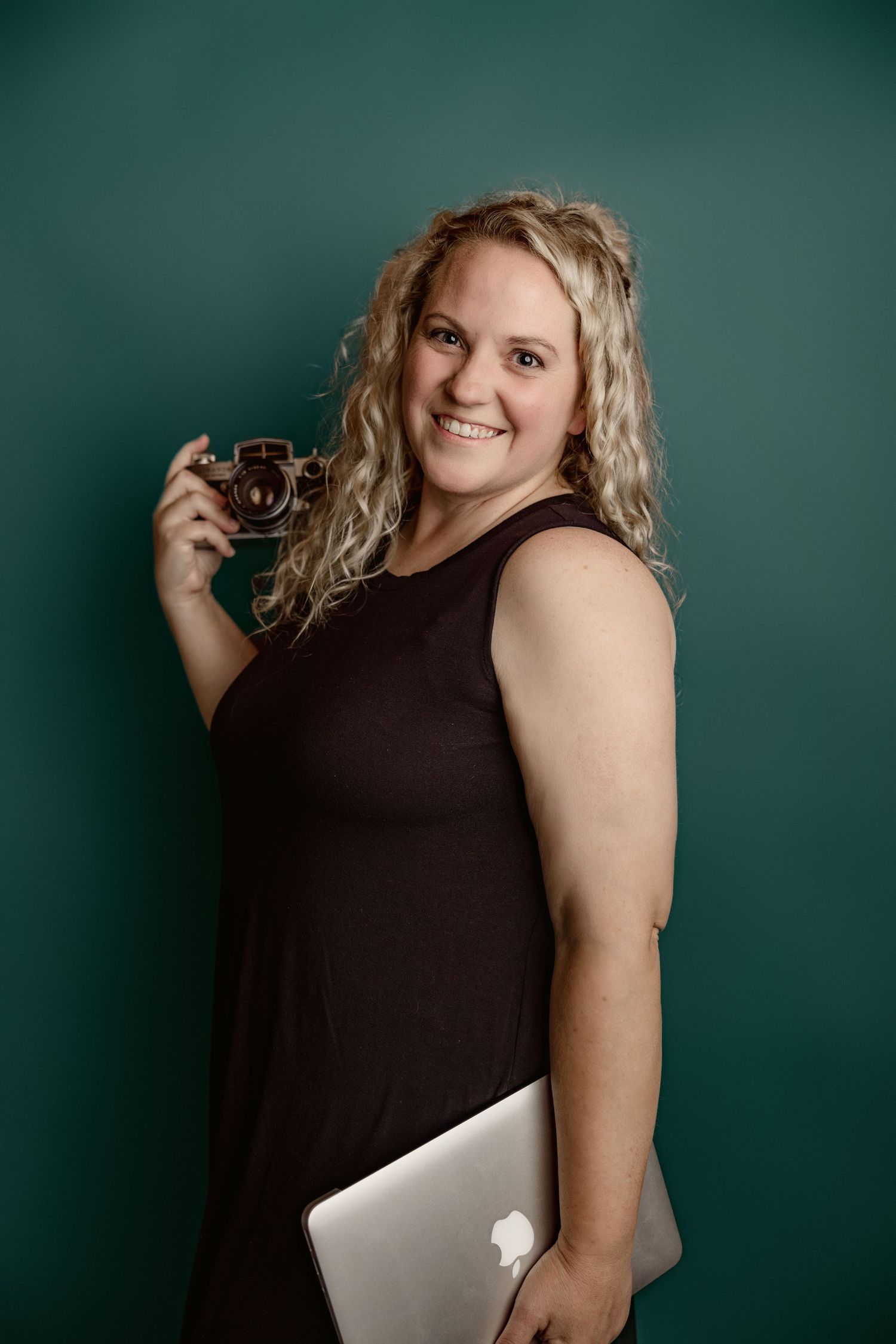 Studio portraits against a dark teal backdrop showing playful poses with camera equipment.