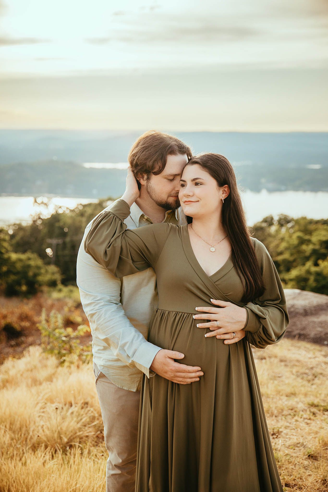 Autumn maternity session in olive green dress with mountain views at golden hour.