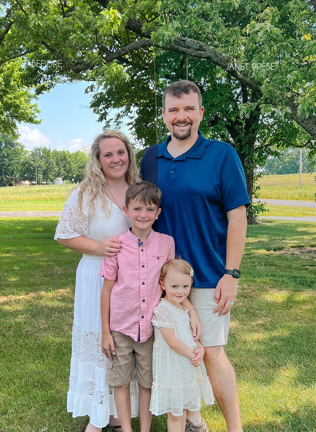 A family poses together outdoors on a sunny summer day in a grassy area with trees.