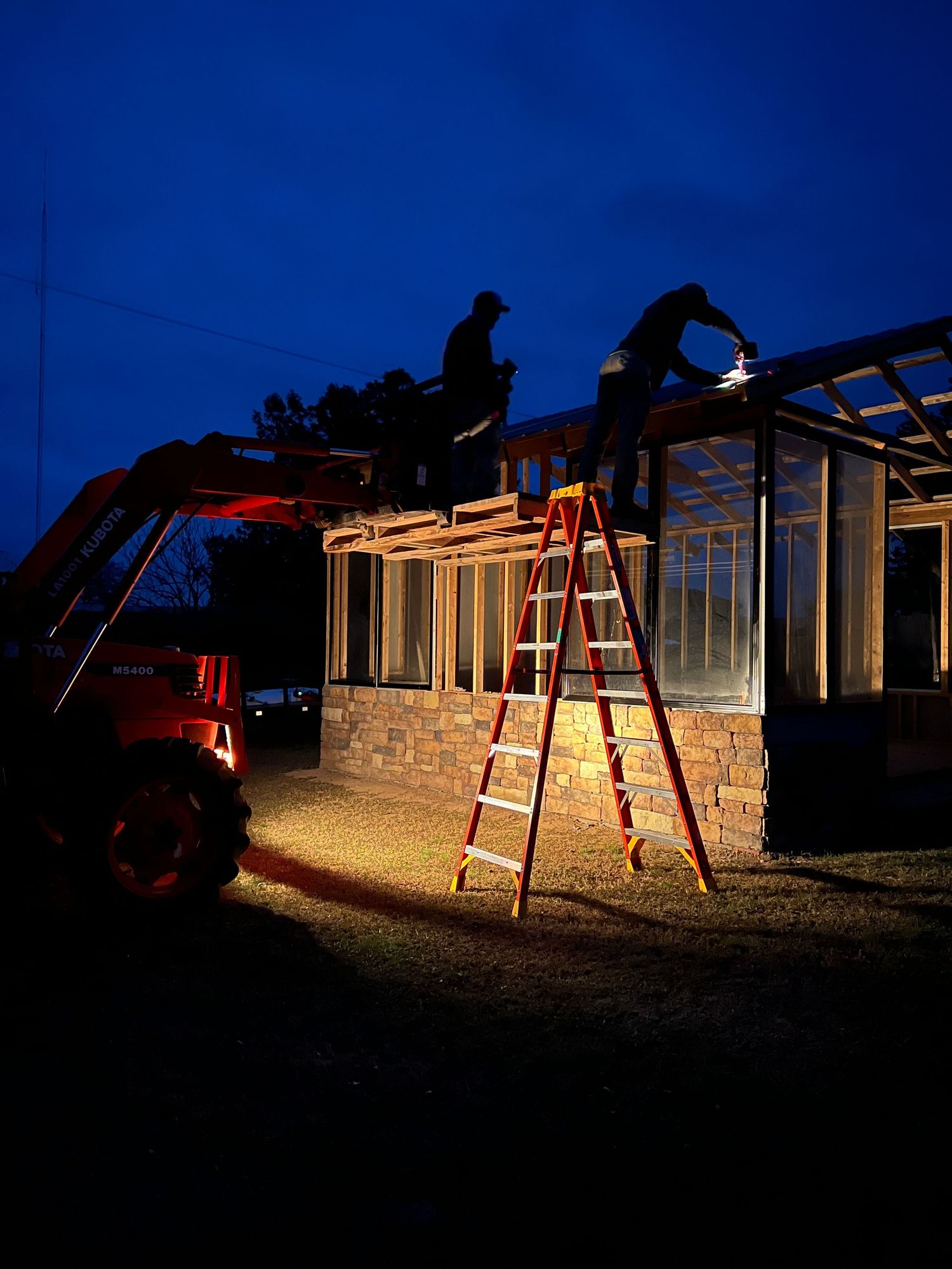 Time-lapse sequence shows red playground swingset illuminated at night against a dark residential building.