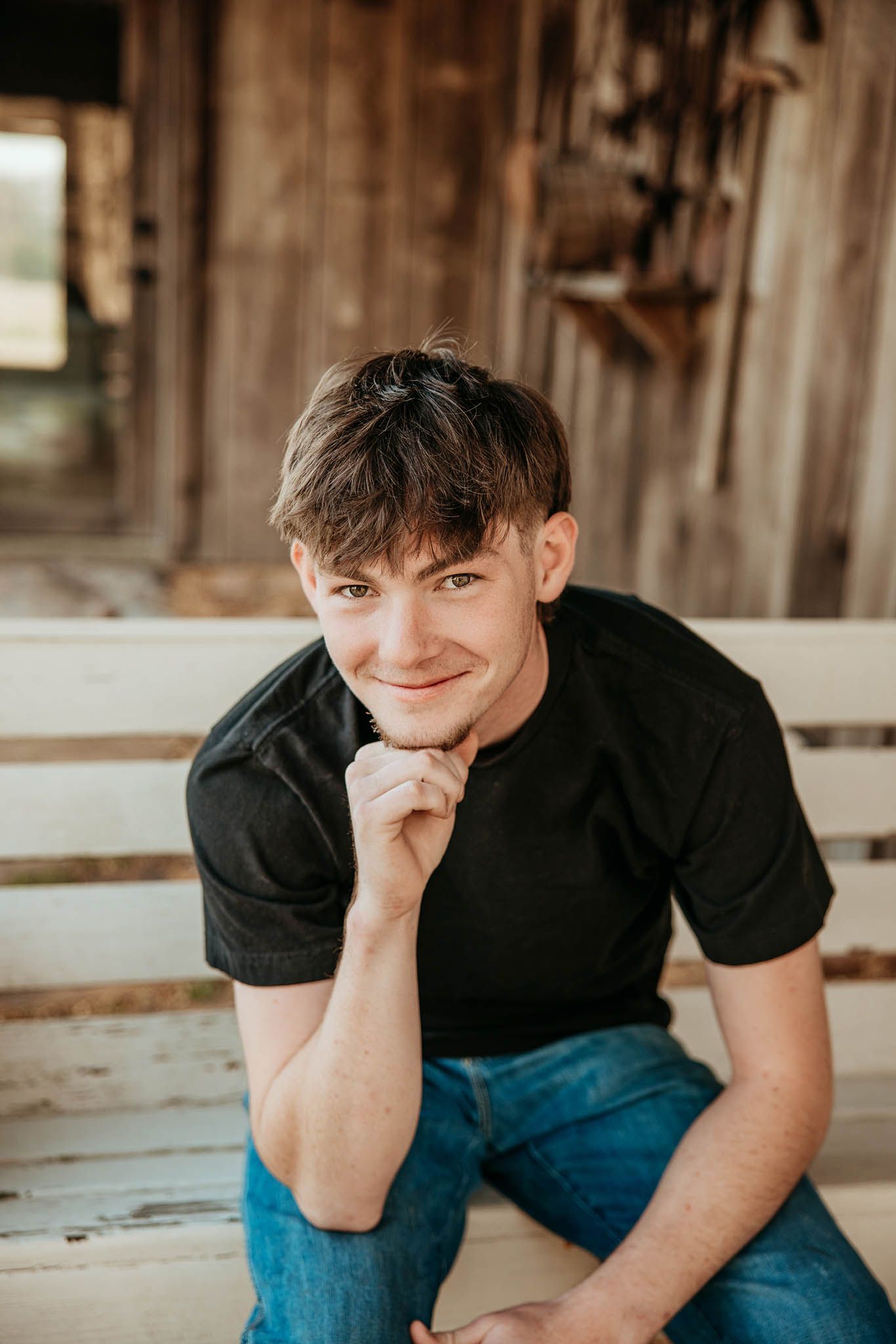 Senior guy in casual black t-shirt and jeans sitting on wooden steps outdoors showing different poses and expressions.