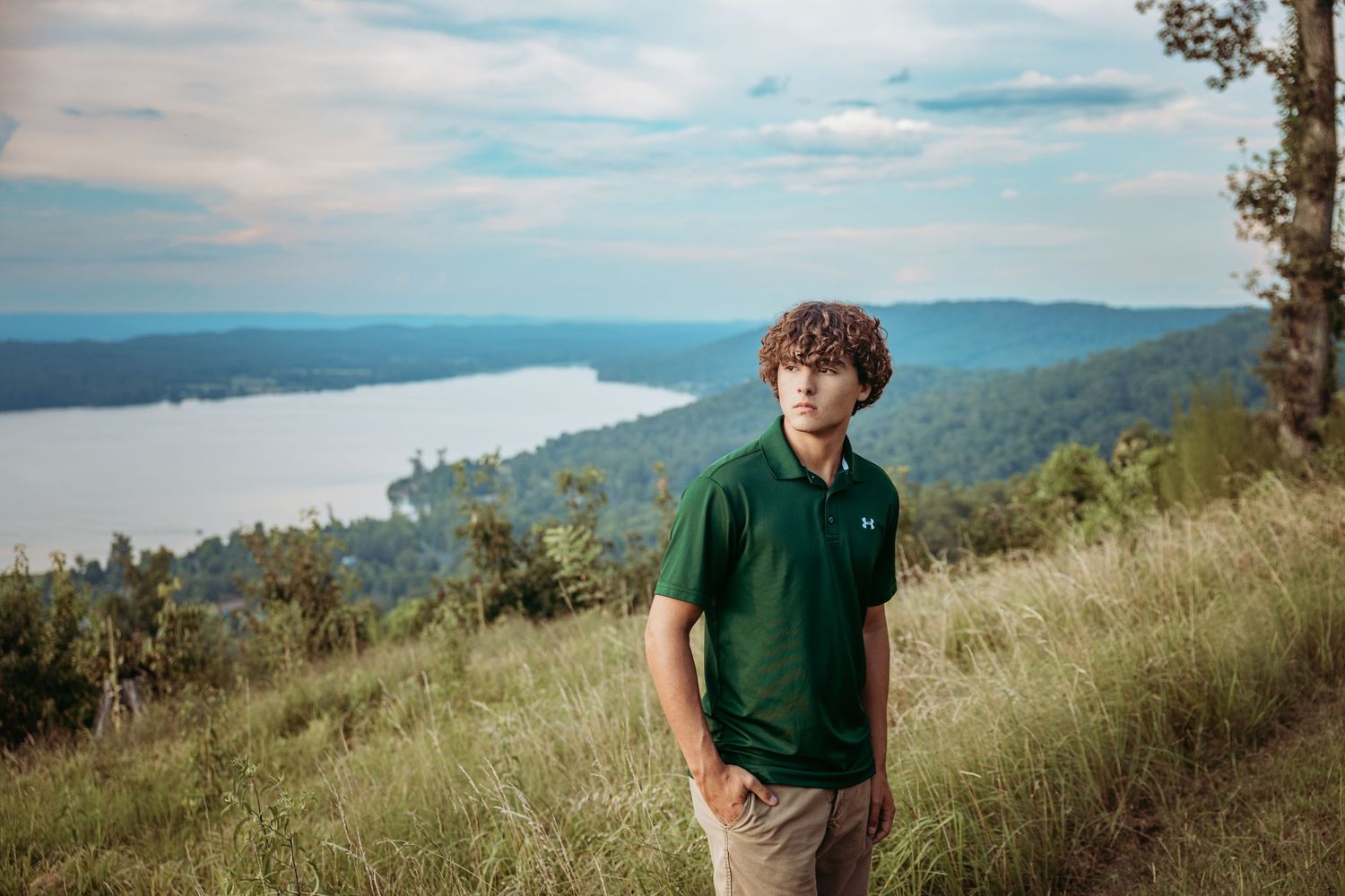 A scenic portrait session at a mountain overlook with rolling hills in the background.