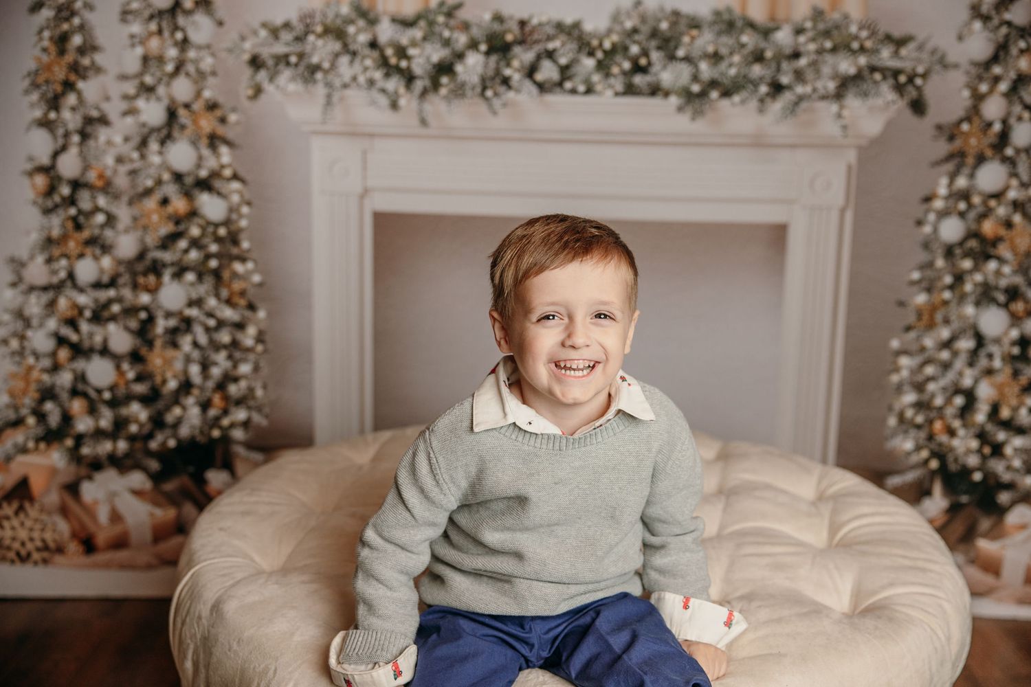 Holiday setting with decorated Christmas tree and cozy white couch.