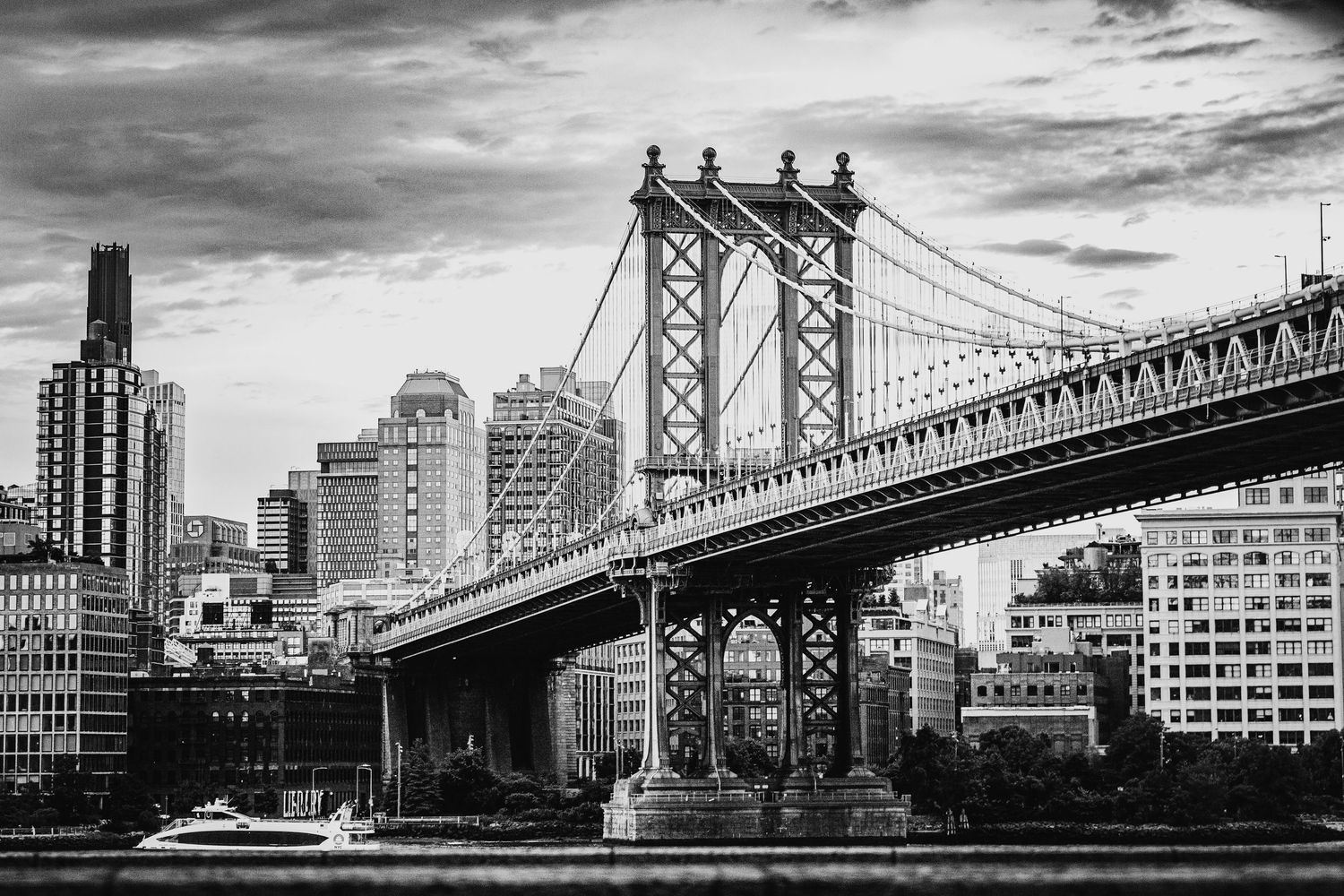 Panoramic black and white cityscape showing multiple bridge spans and urban architecture.