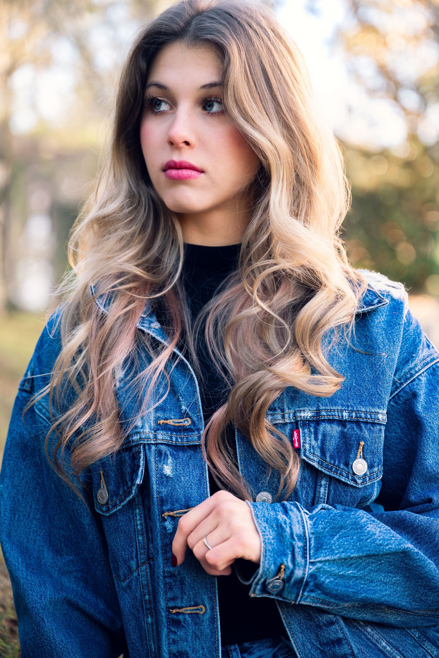 Stylish denim jacket look captured in outdoor portrait series.