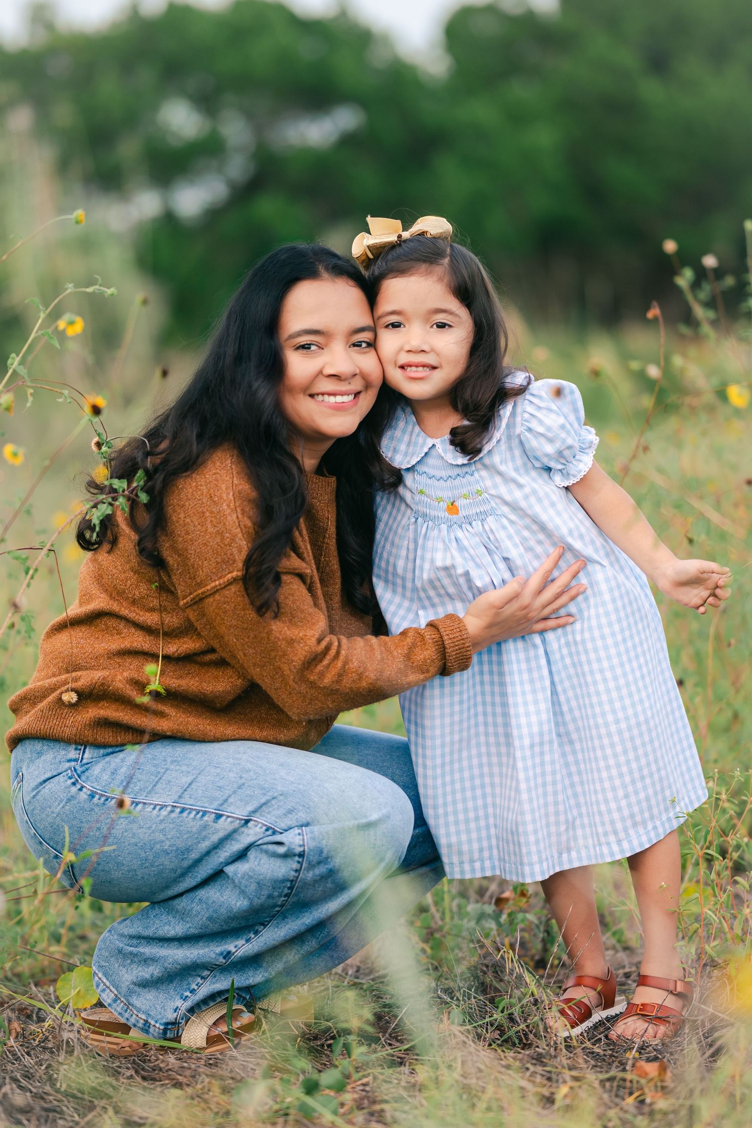 A tender moment shared between two people in a field of yellow flowers.