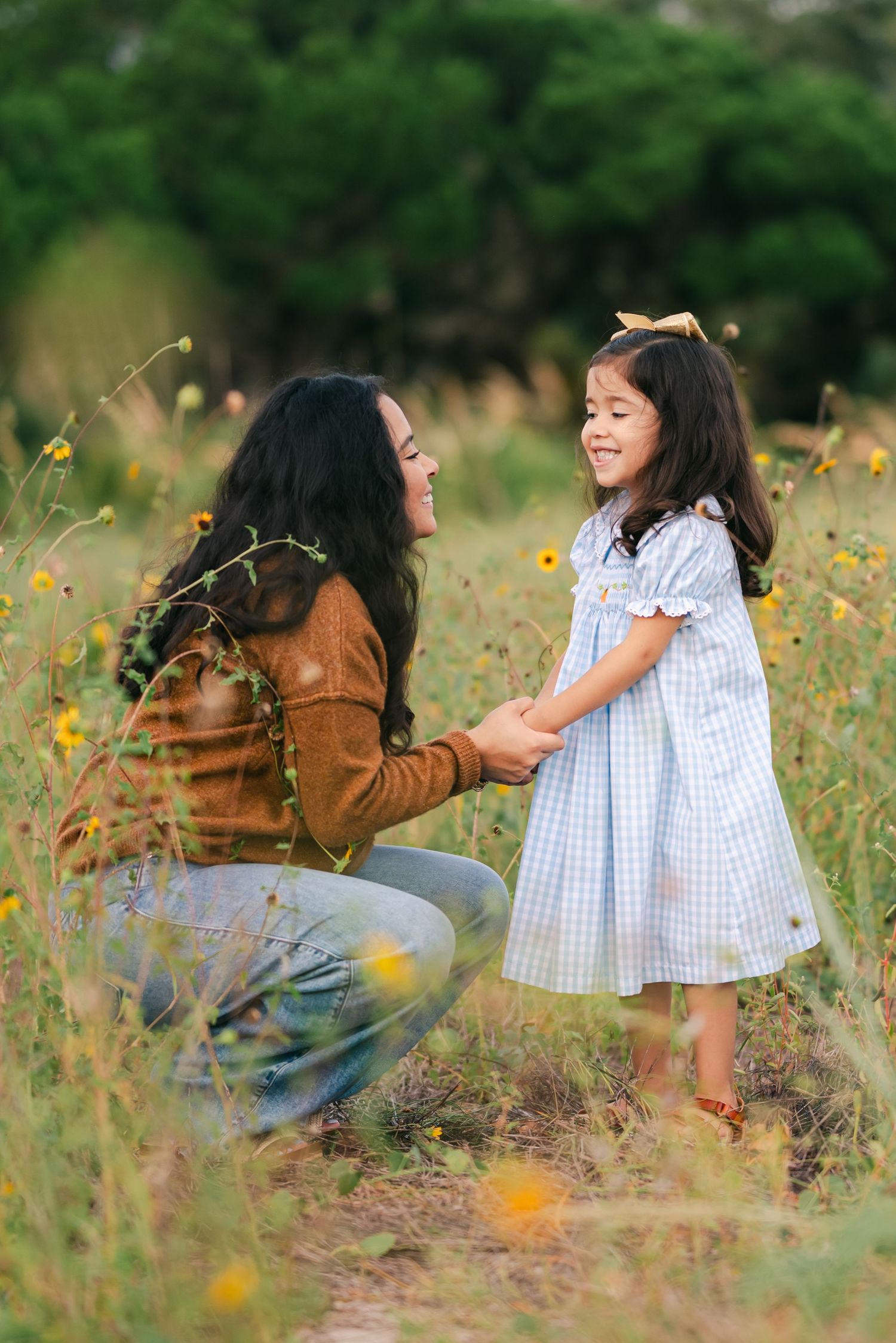 A heartwarming interaction between two people in a field of yellow wildflowers.