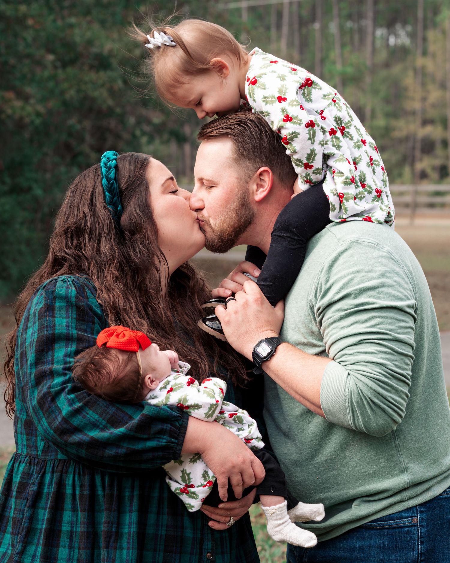 Intimate family moment captured during outdoor Christmas photo session.