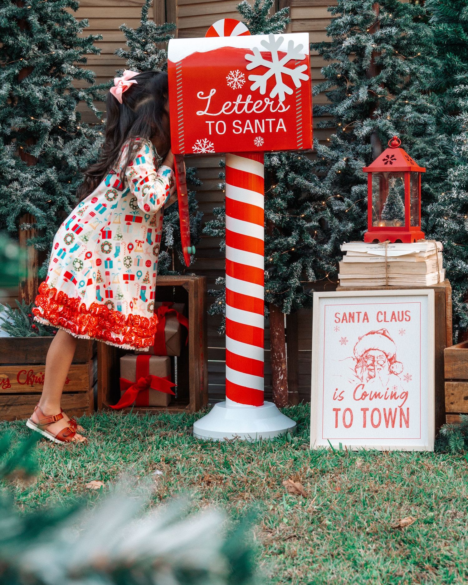 A whimsical Christmas scene with Letters to Santa mailbox and holiday decorations.