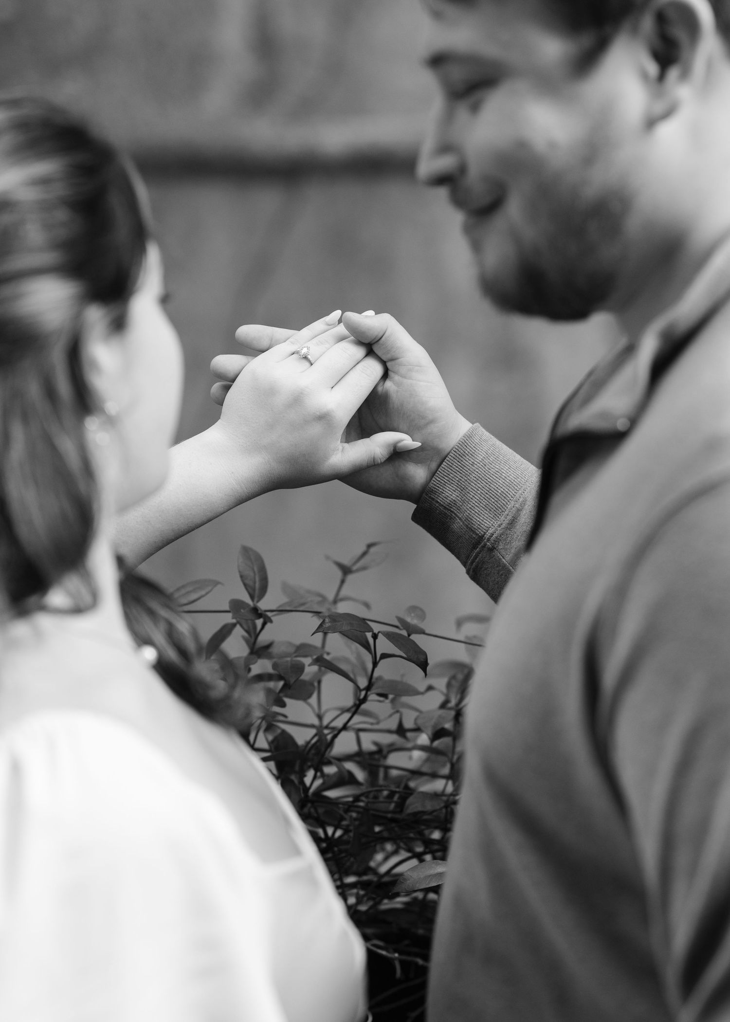 Black and white romantic moment captured during outdoor photo session.