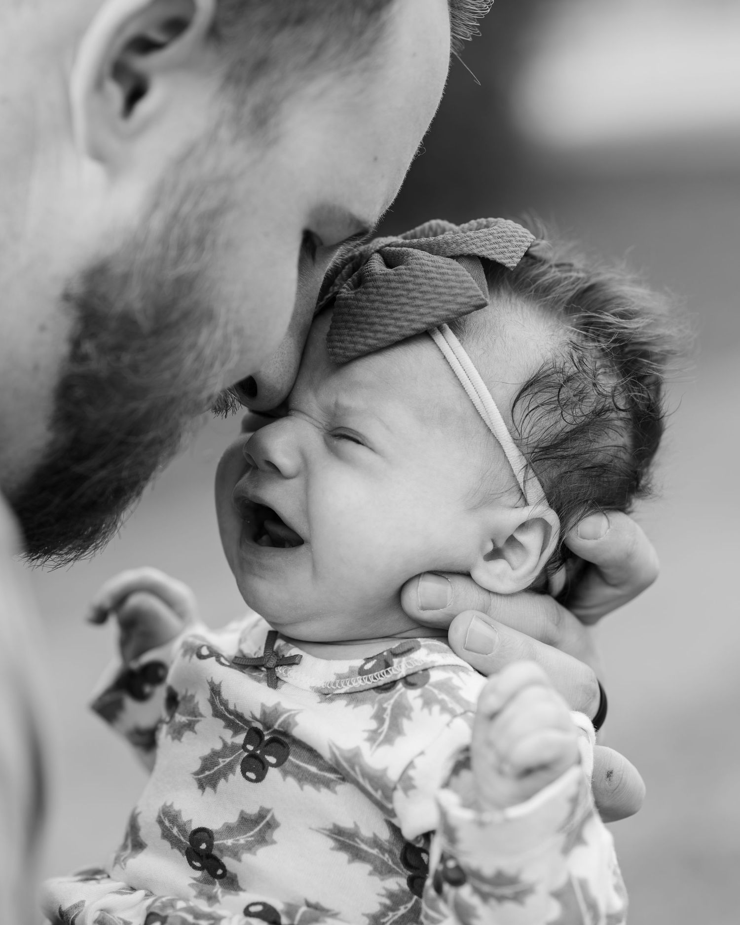 Intimate black and white portrait showing tender family moment.
