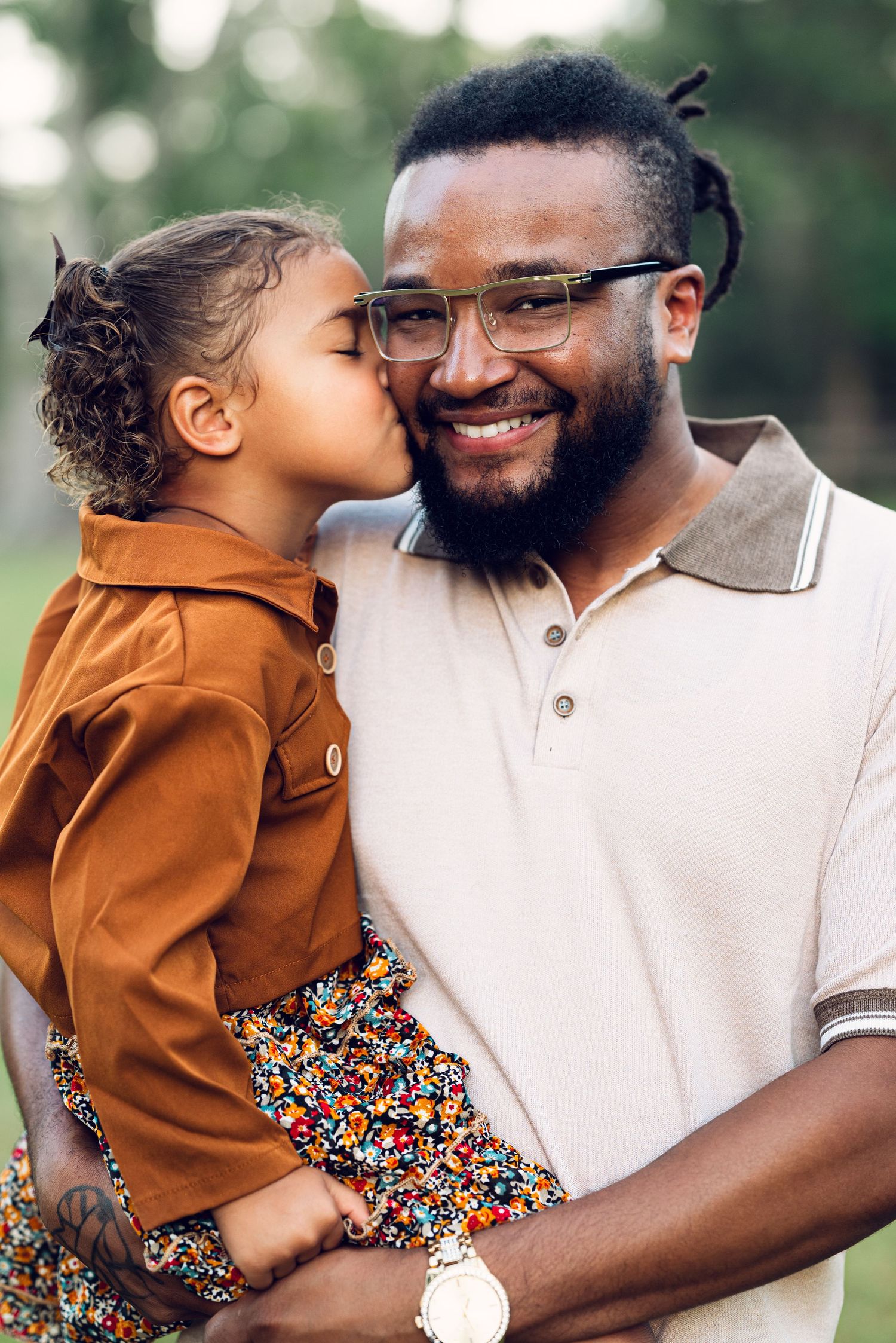 A tender outdoor portrait showing affection and joy between two people.