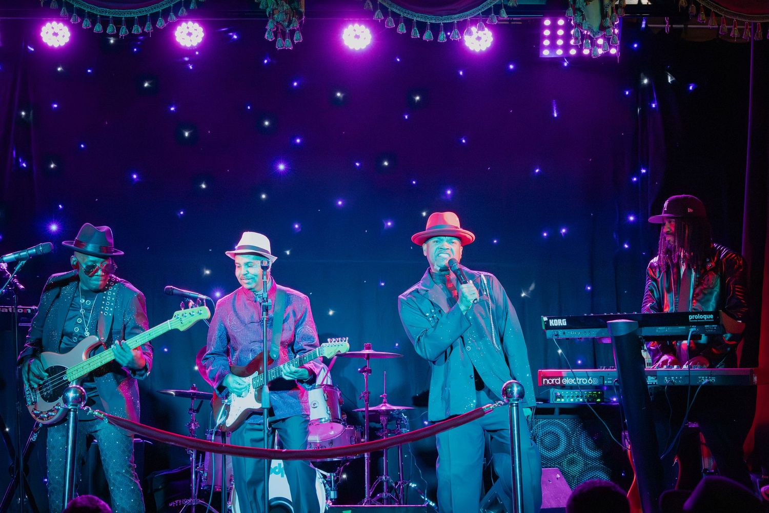 Stage setup with purple mood lighting and blue star effects creating atmospheric concert ambiance.