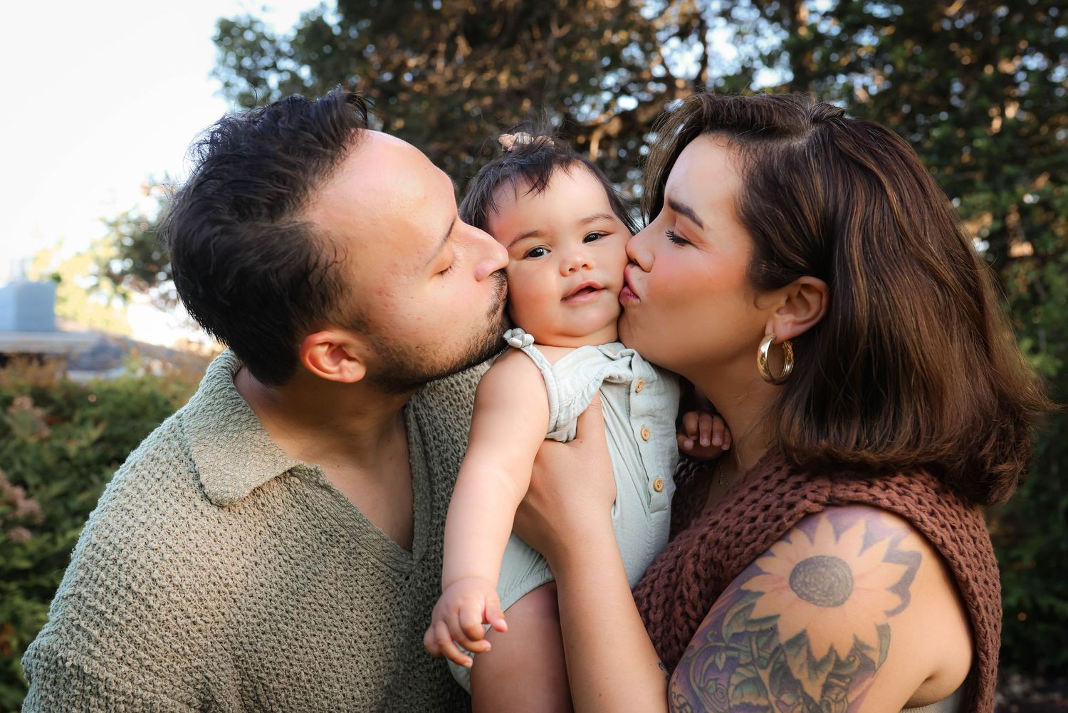 Candid family moments captured during outdoor photo session.