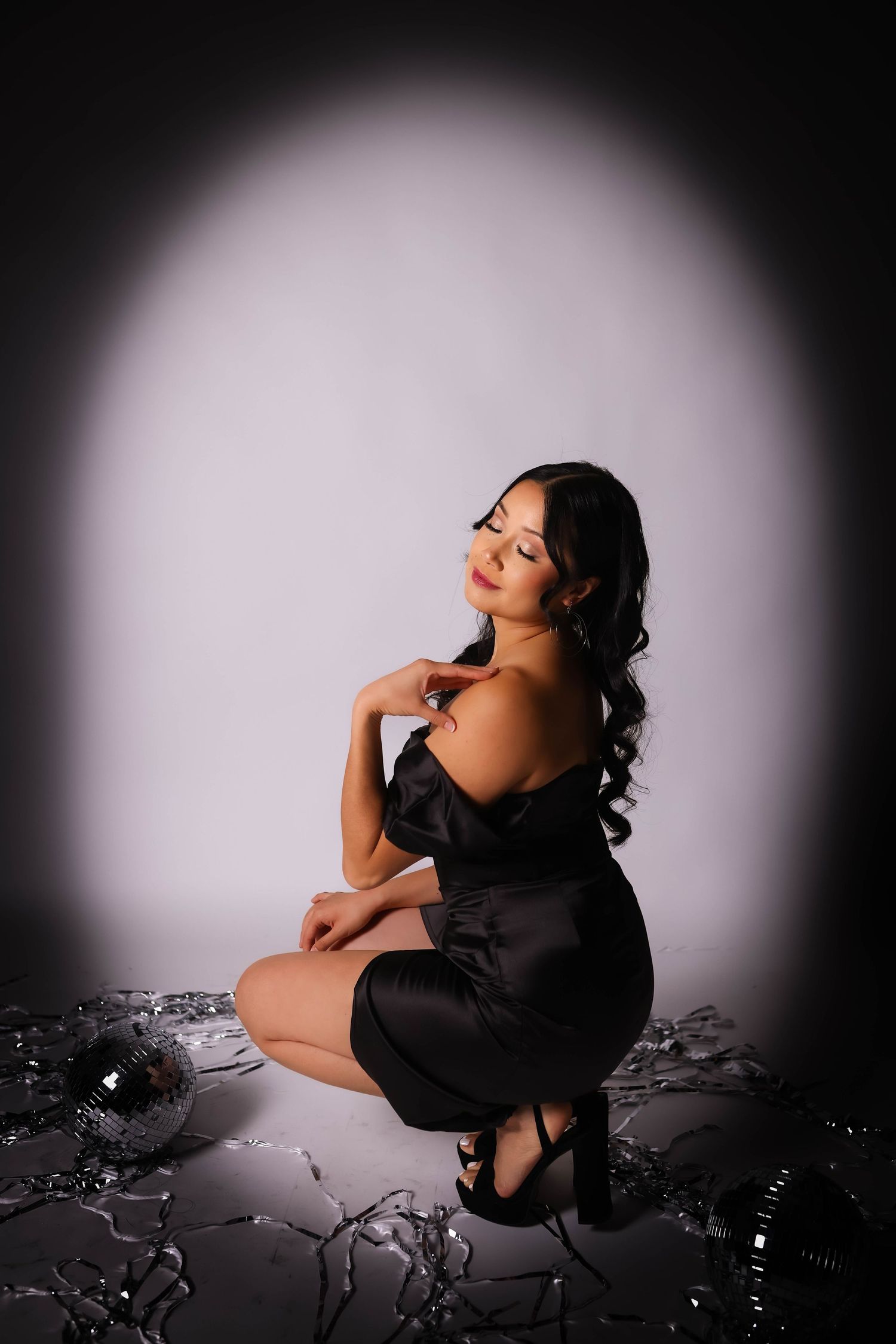 Artistic portrait with dramatic spotlight effect on black background.