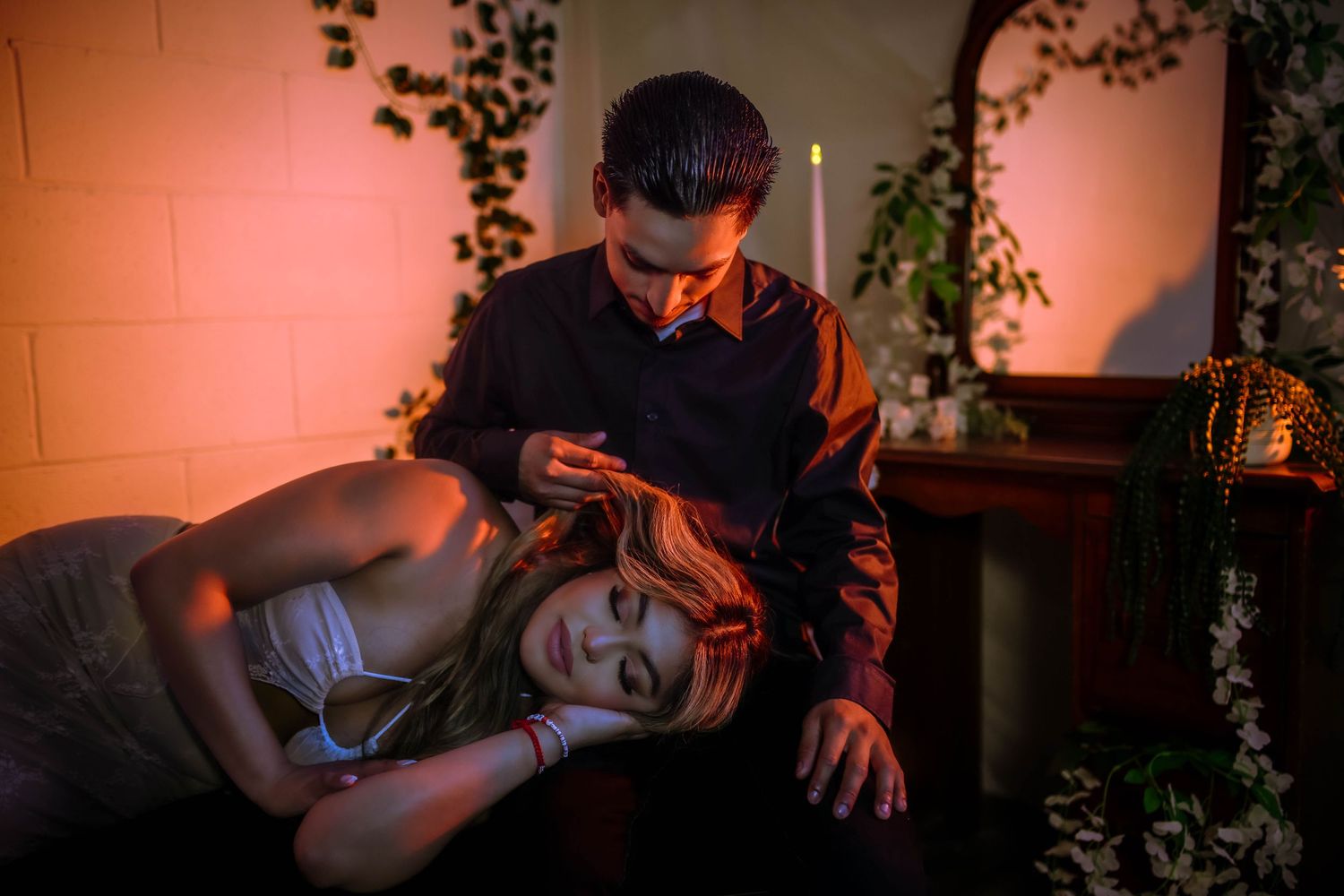 A sequence of low-lit photos showing a couple embracing with warm ambient lighting.