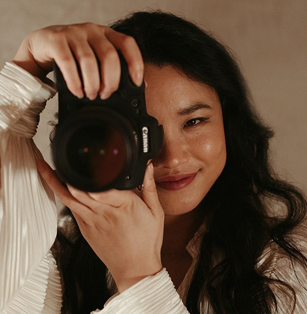 Close-up shots of photographer holding and looking through a camera lens.
