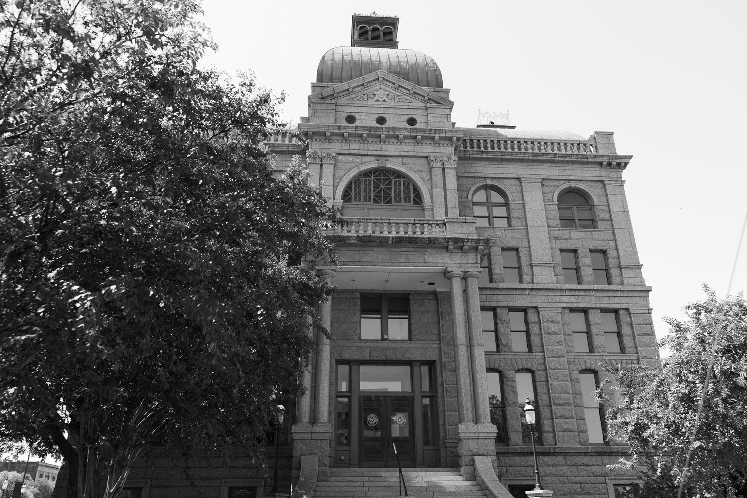Historic courthouse building with ornate dome architecture and classical design elements shown from multiple angles.