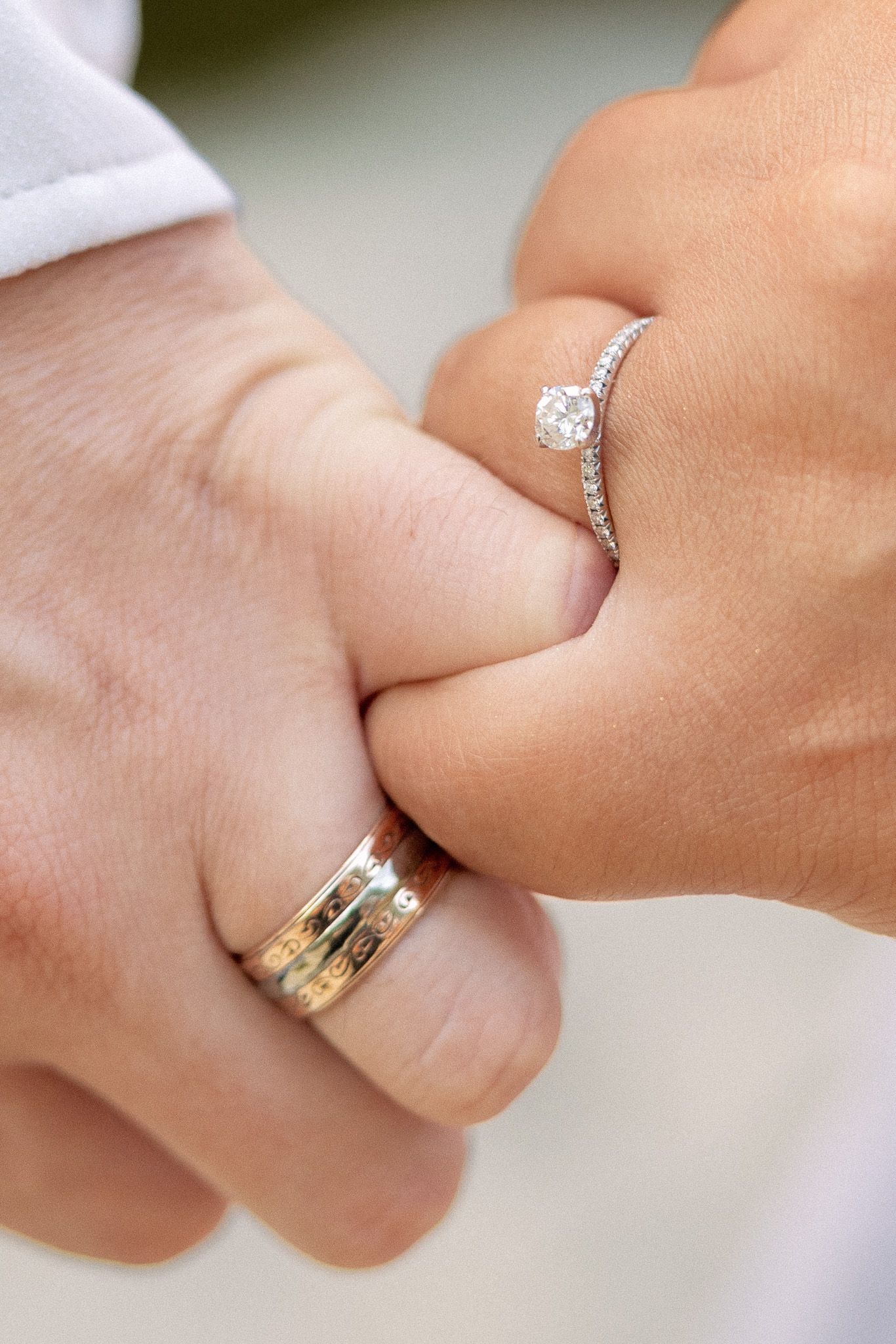 Close-up shots of hands wearing engagement and wedding rings.