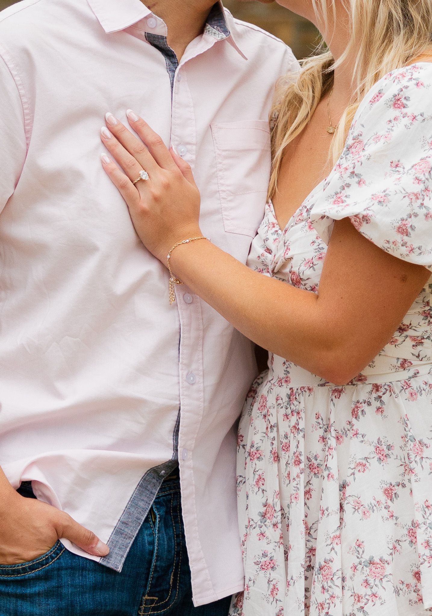 A couple in casual attire embracing in a romantic pose against a white background.