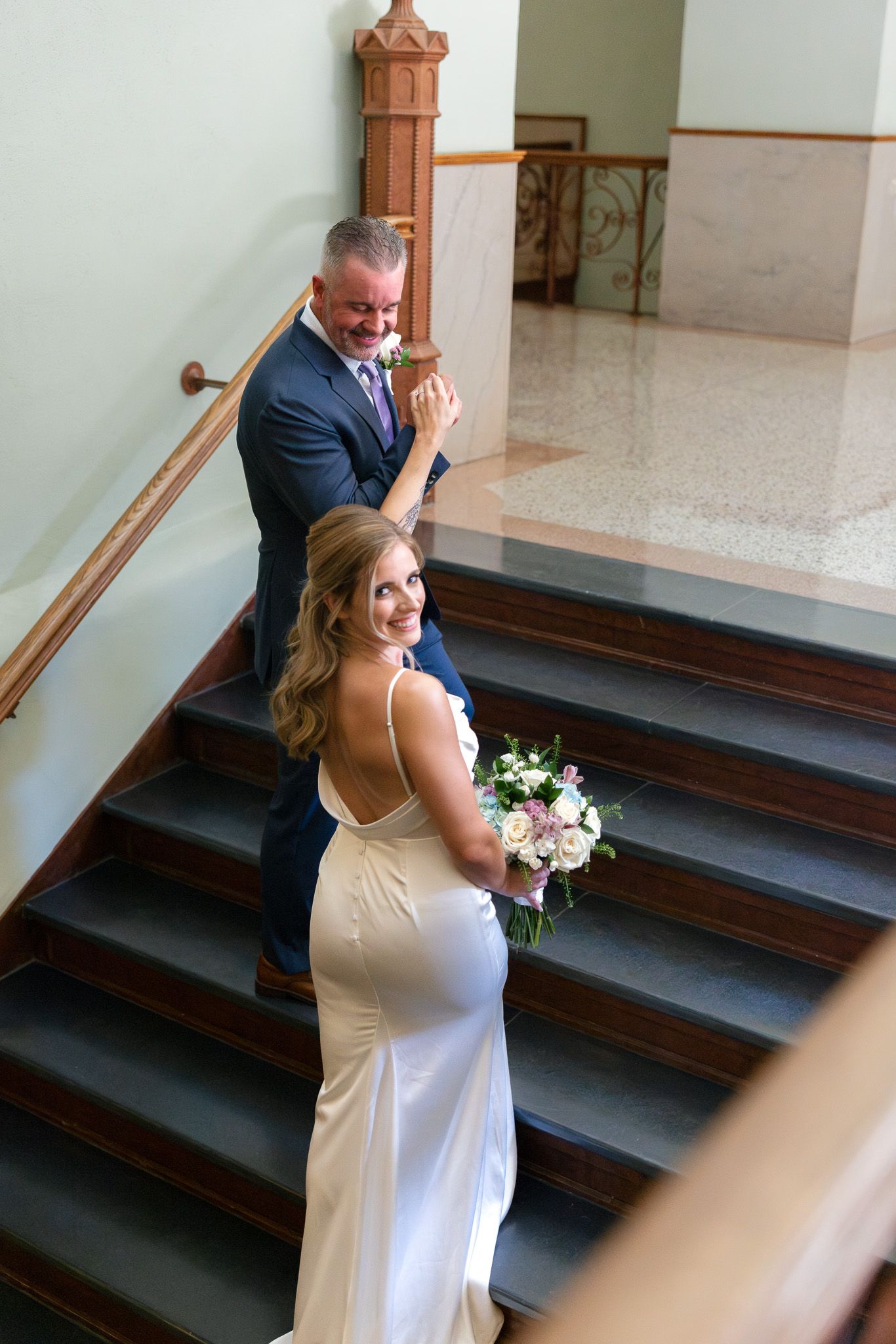 A series of four photos showing an emotional first look moment on church steps between a bride and her father.