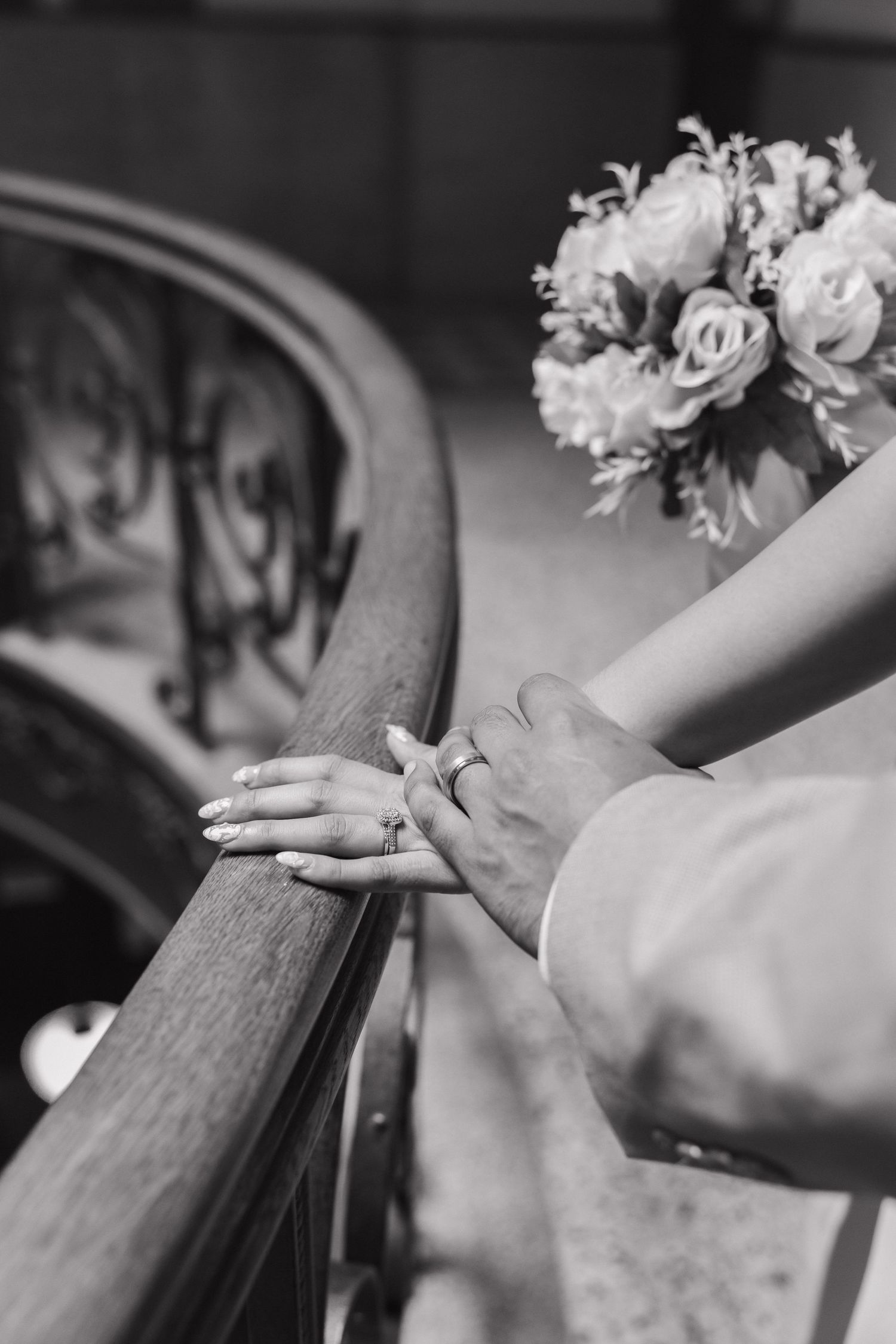 Black and white photo series showing hands resting on a wooden church pew during a wedding ceremony.