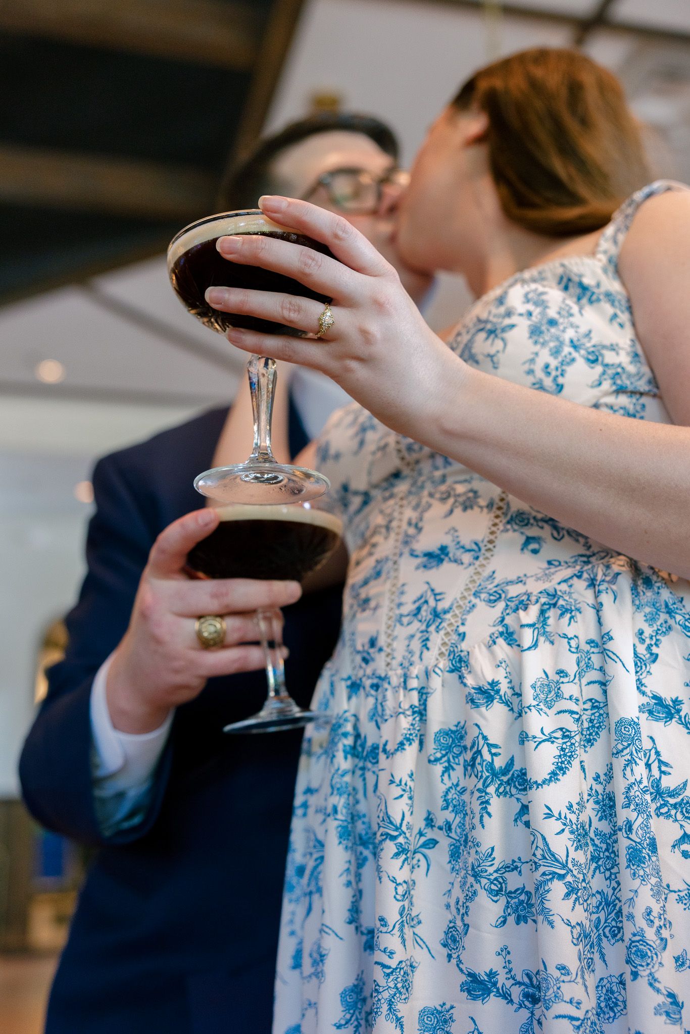 Candid moments of people holding wine glasses at an indoor celebration.