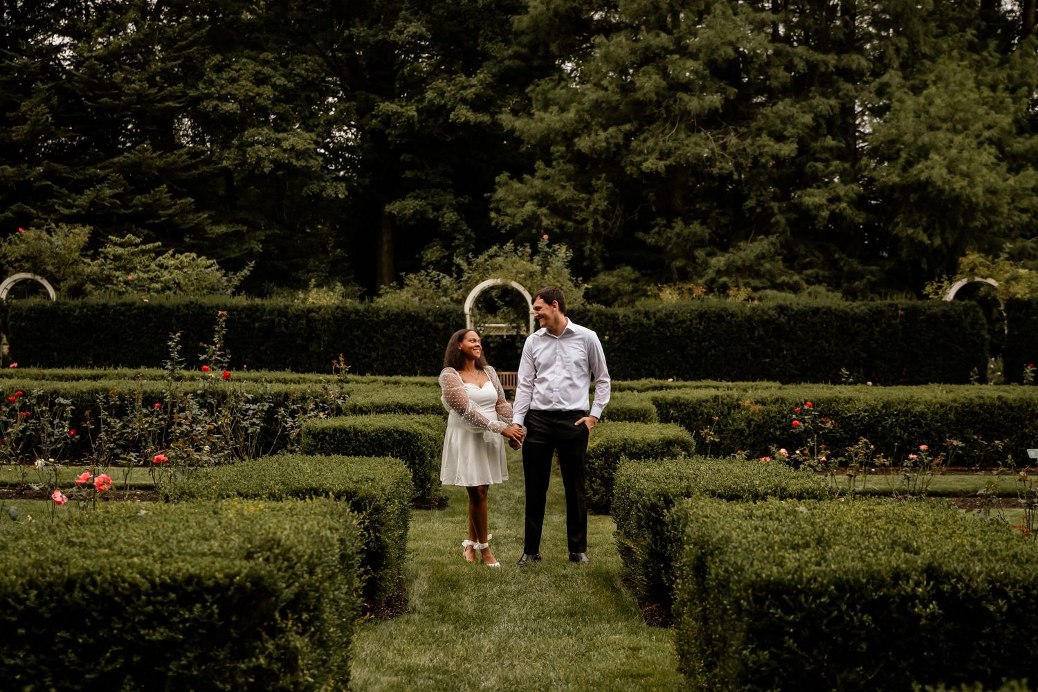 A series of connected wedding photos showing a couple walking through a lush garden setting at different angles.