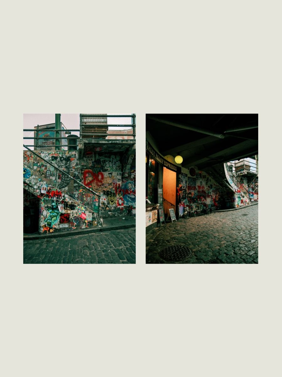 Seattle Post Alley gum wall collage showing graffiti-covered stairs and dark cobblestone tunnel with orange door.