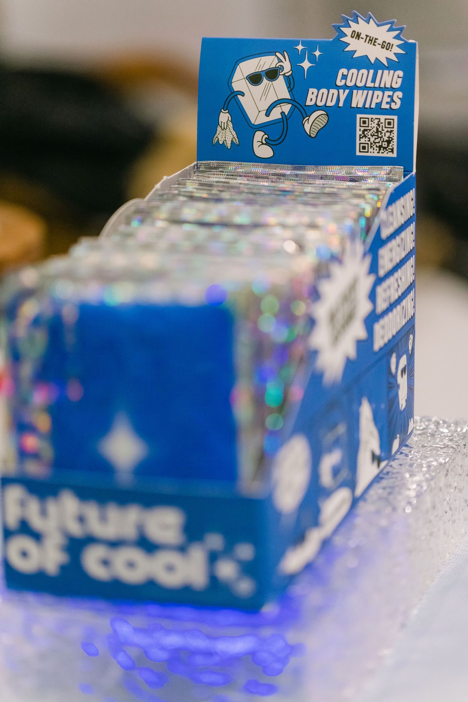Future of Cool cooling body wipes display box with holographic blue packaging and promotional signage.