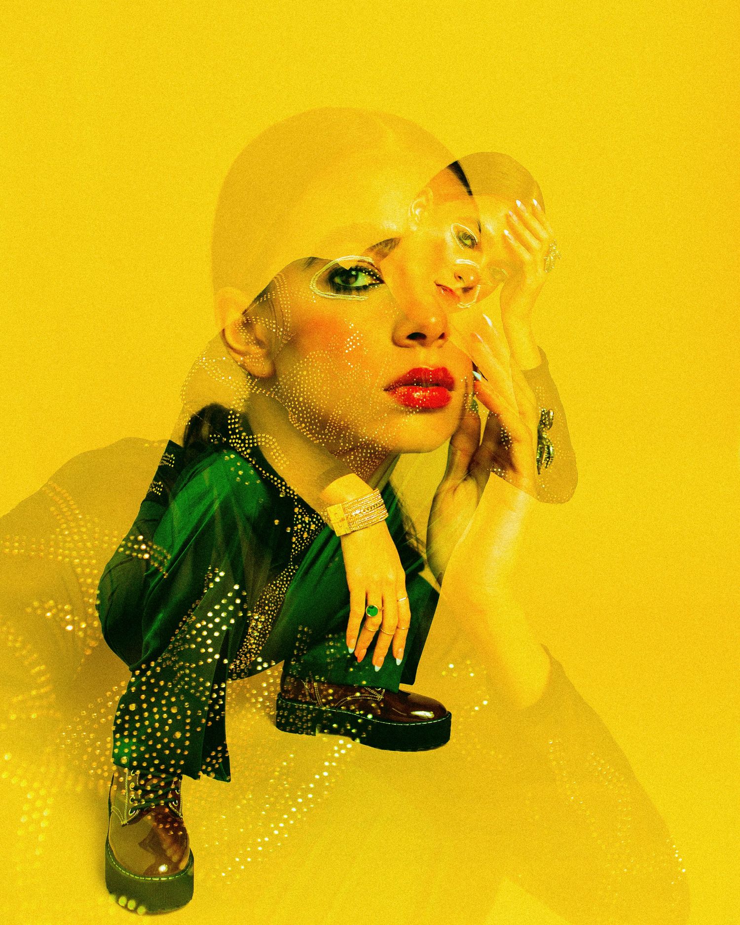 Woman in green sequin jacket with bold red lips and dramatic makeup poses against vibrant yellow background.