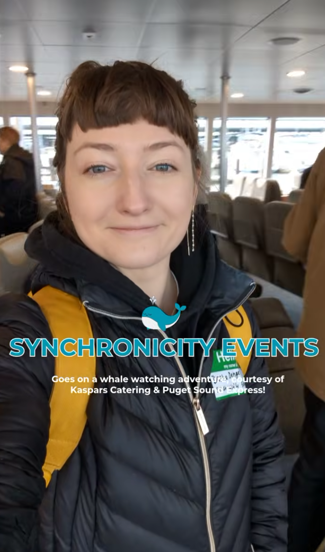 Woman on whale watching boat with Synchronicity Events text, courtesy of Kaspars Catering & Puget Sound Express.