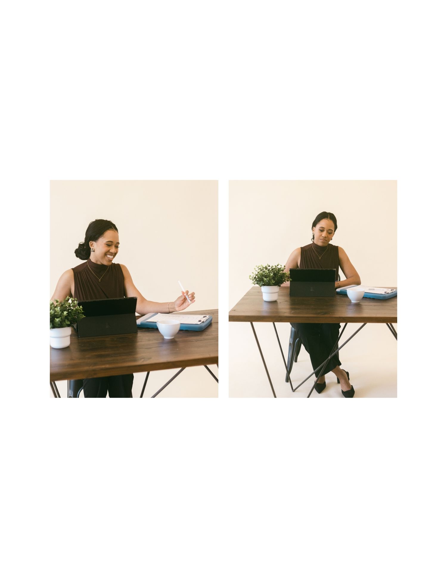 Woman sitting at a wooden desk with a tablet, smiling and gesturing in a bright workspace.
