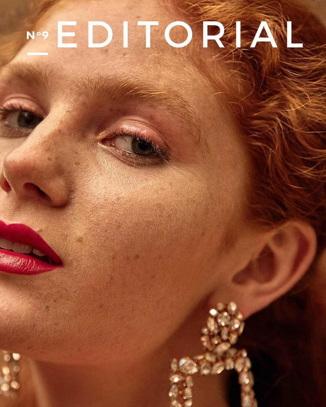 Editorial magazine No.9 cover closeup of redhead model with pink lips and crystal earrings.