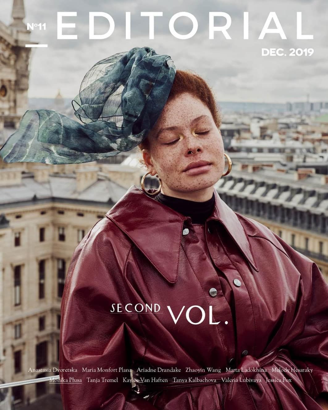 Editorial magazine cover featuring redhead model in burgundy leather jacket with blue headpiece in Paris, Dec. 2019.