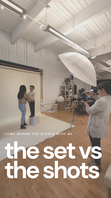 Behind-the-scenes photo shoot in a studio with models posing against white backdrop, photographer with umbrella light.