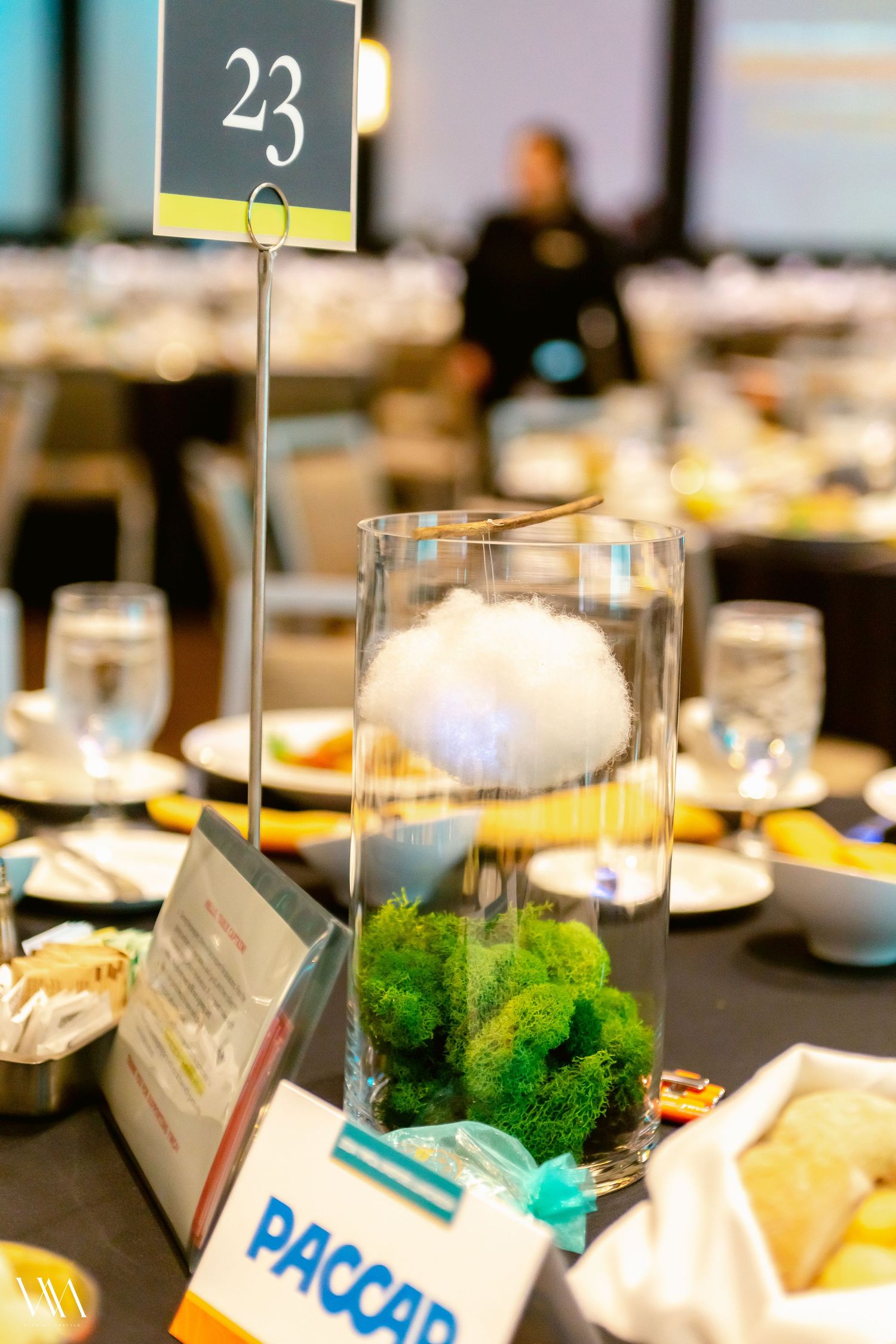 Table 23 centerpiece with glass vase containing moss and cotton, set at a formal PACCAR corporate event.