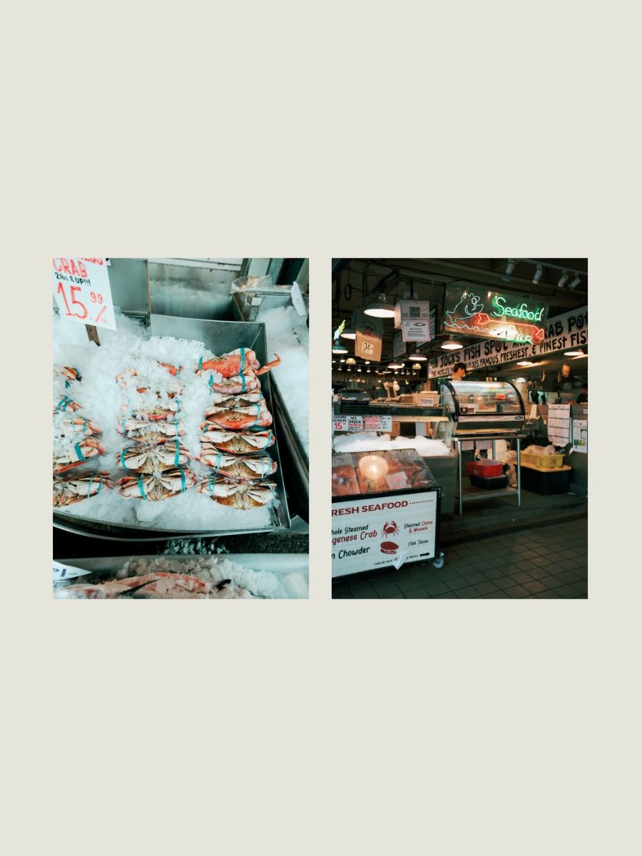 Fresh Dungeness crabs displayed on ice at Pike Place Market seafood stall in Seattle, Washington.