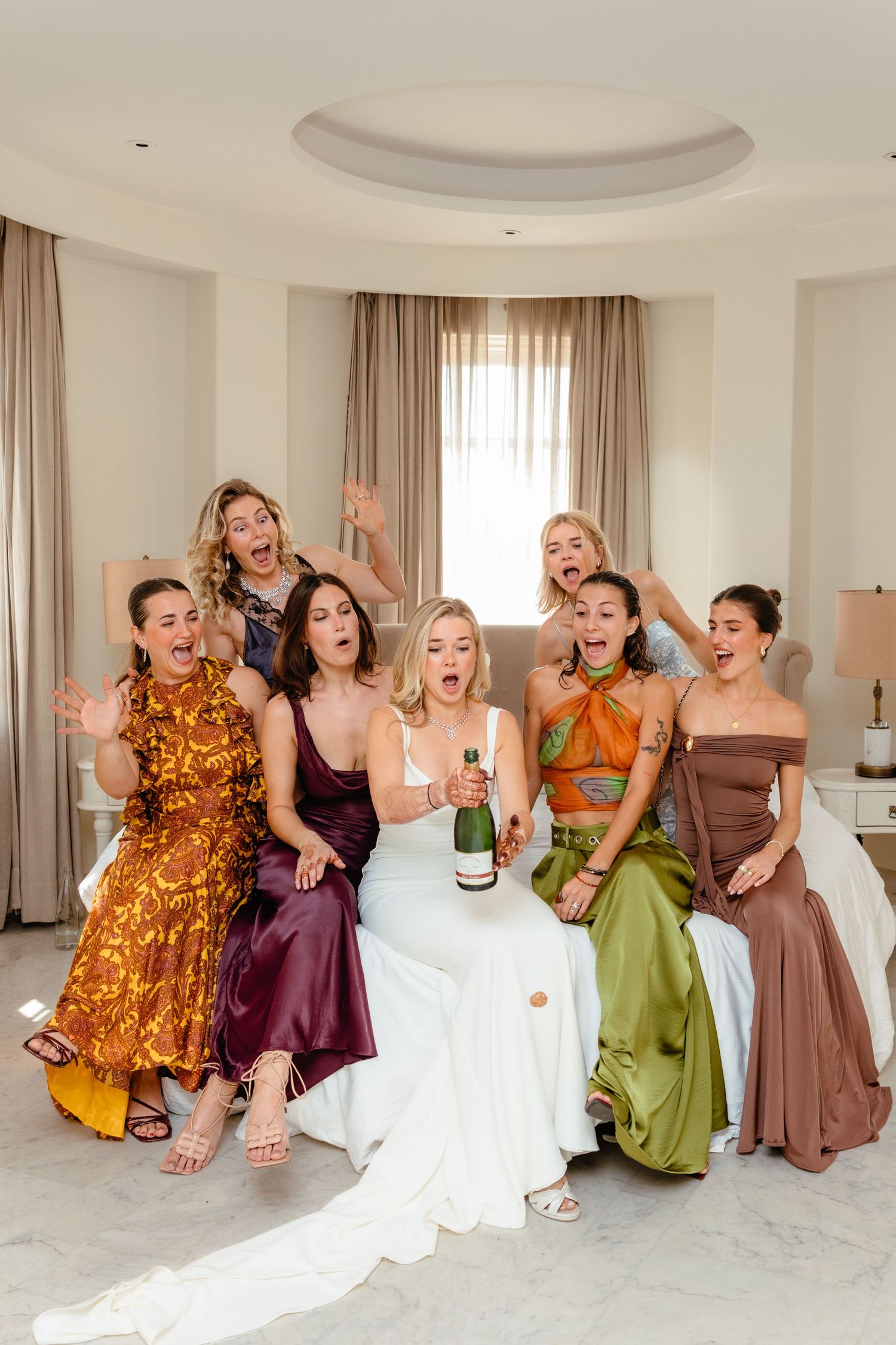 Wedding party in colorful dresses laughs and poses together in sequence of candid celebration photos.