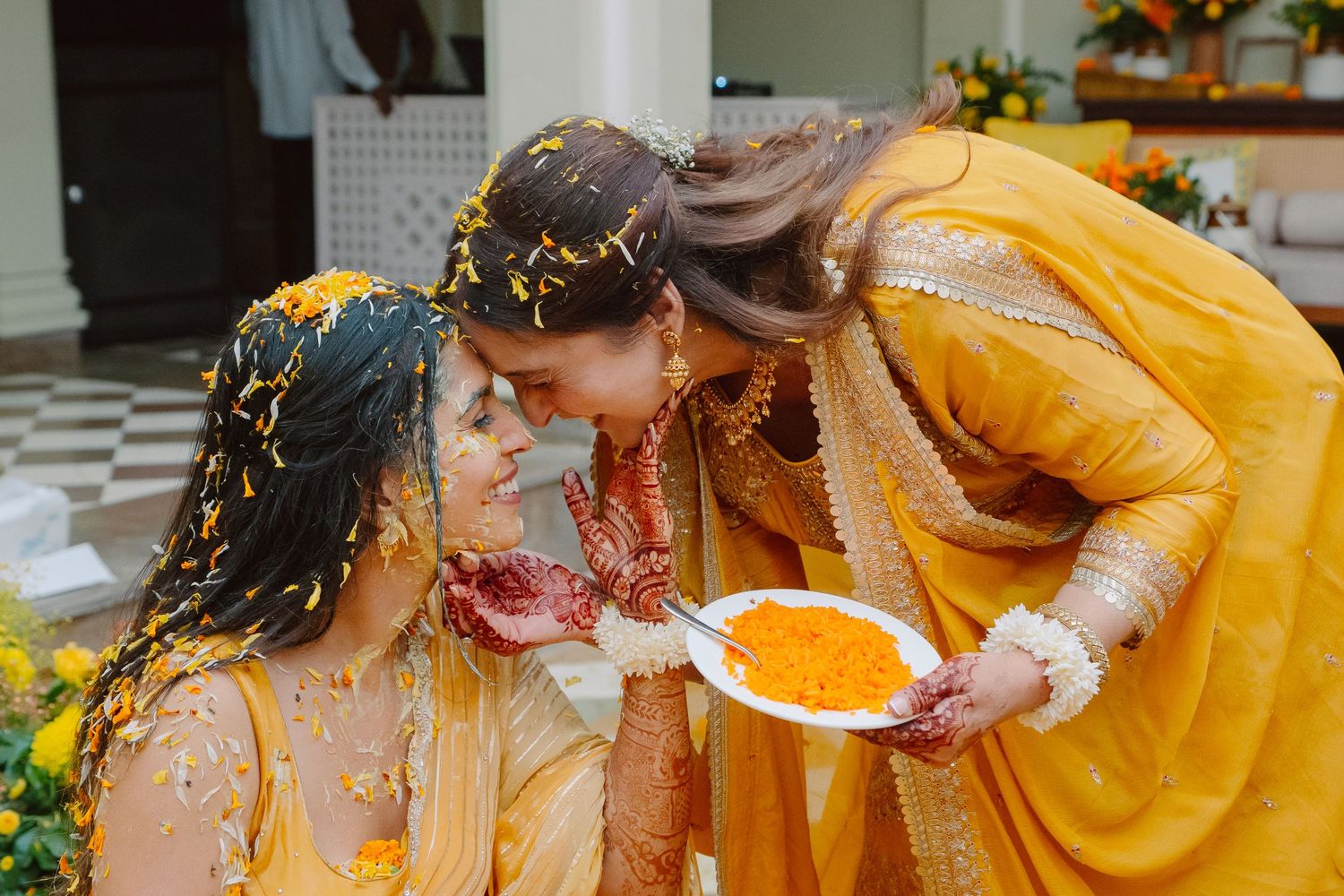 Traditional Haldi ceremony showing application of turmeric paste during pre-wedding ritual.