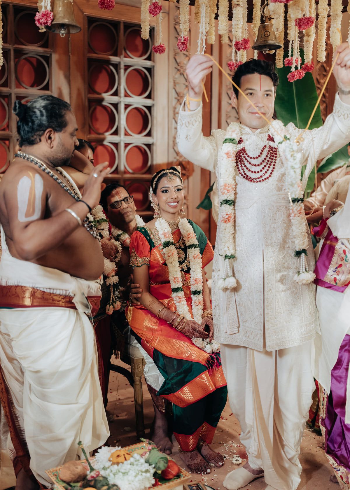 Traditional wedding ceremony with decorative elements and cultural attire in an ornate setting.