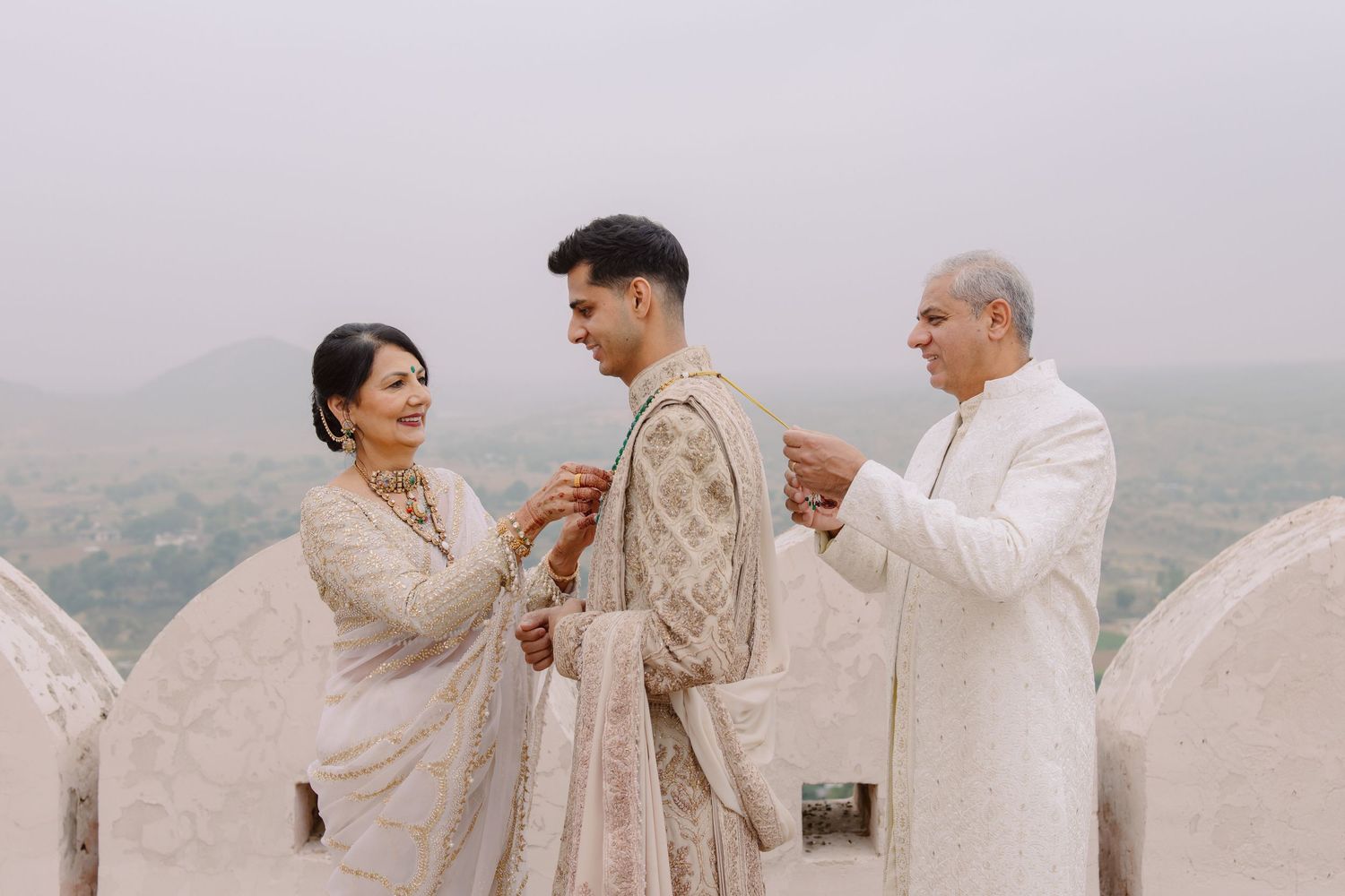 A traditional Indian wedding ceremony takes place on a misty rooftop terrace.