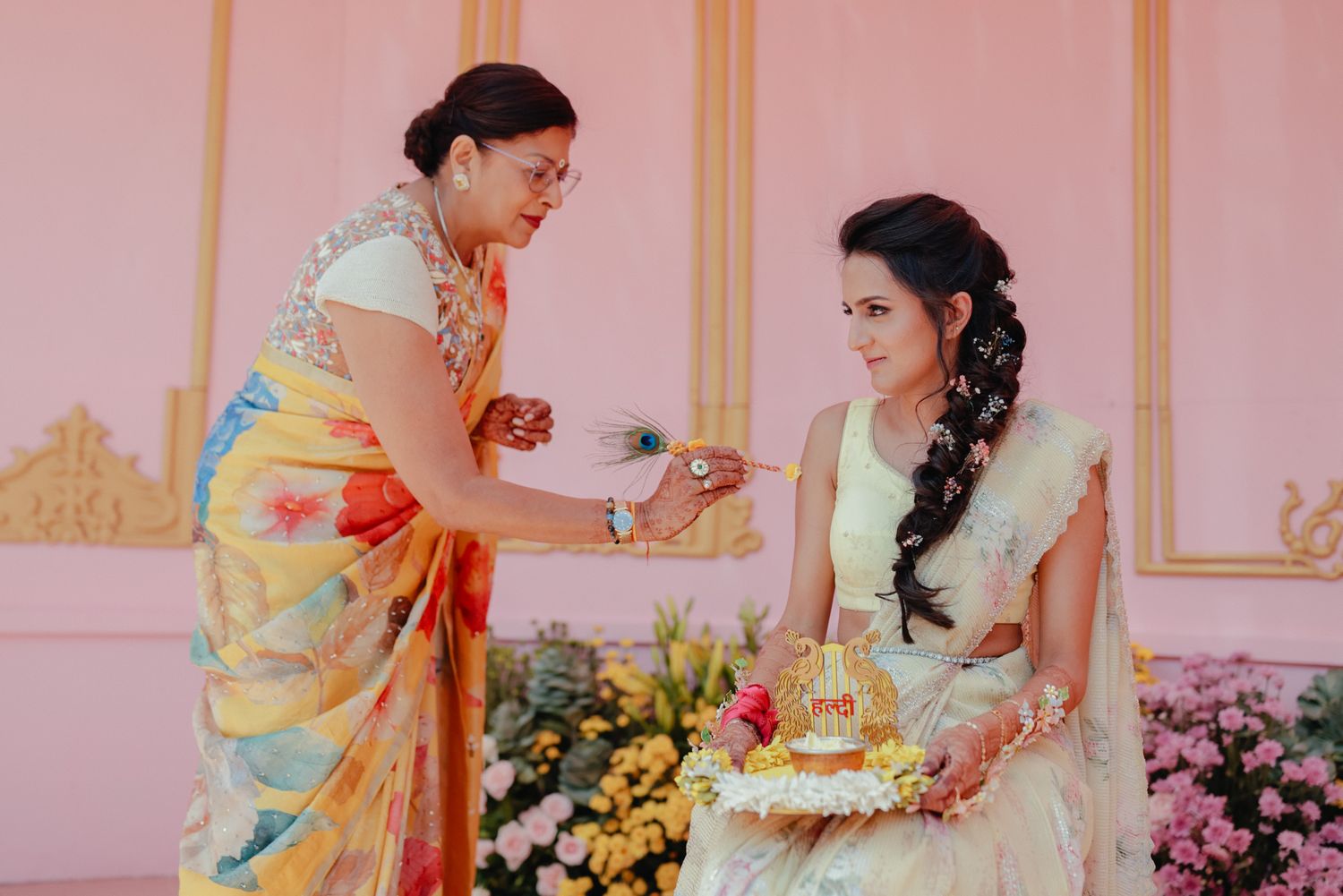 A series of traditional Indian wedding ceremony photos showing hands exchanging garlands and ceremonial rituals.